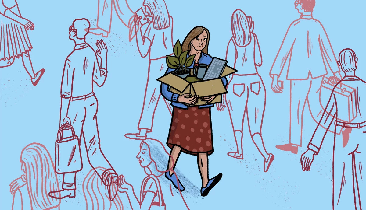 a woman with a sad expression and carrying a box of office belongings while walking the opposite way of a group of people