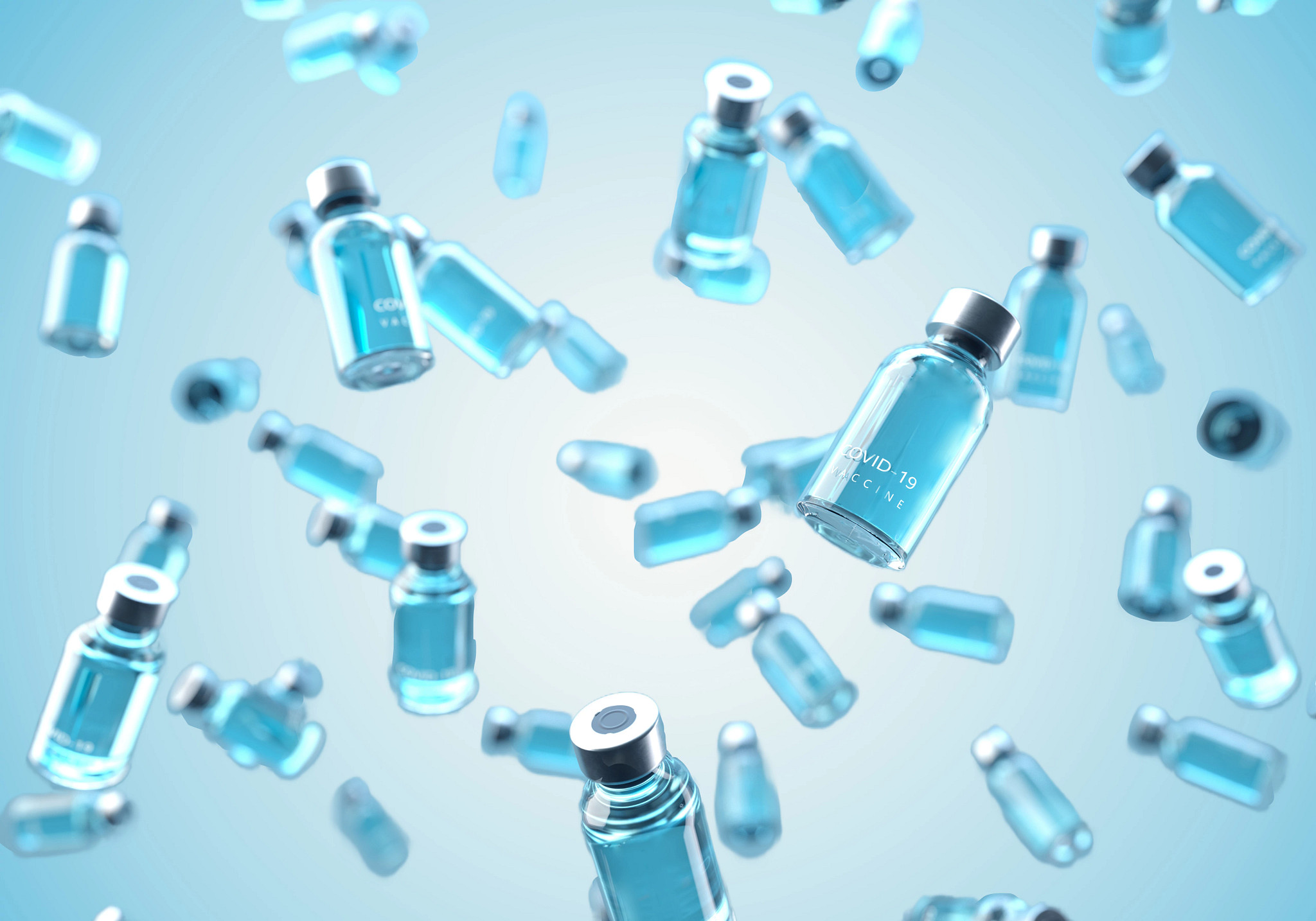 Digital generated image of COVID-19 vaccine bottles falling against blue background.