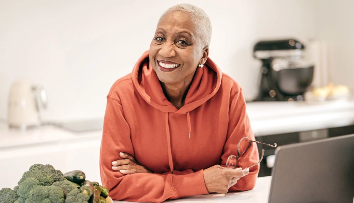 A woman smiling and listening.