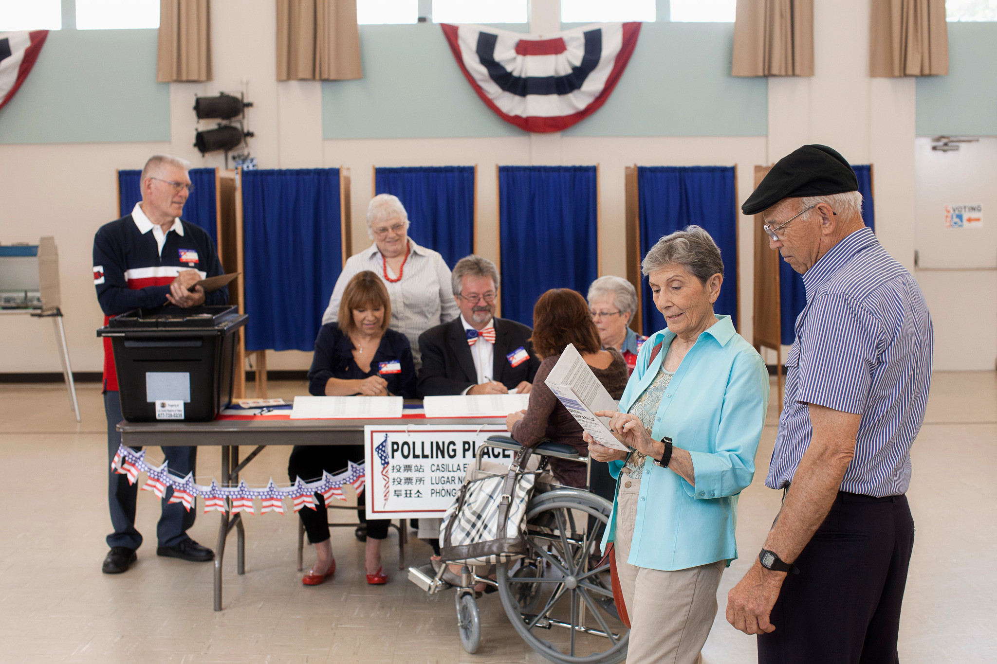 Workers working at registration table in polling place