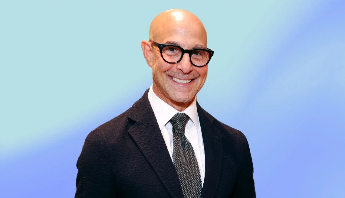 Stanley Tucci interview Stanley Tucci against light blue ombre background