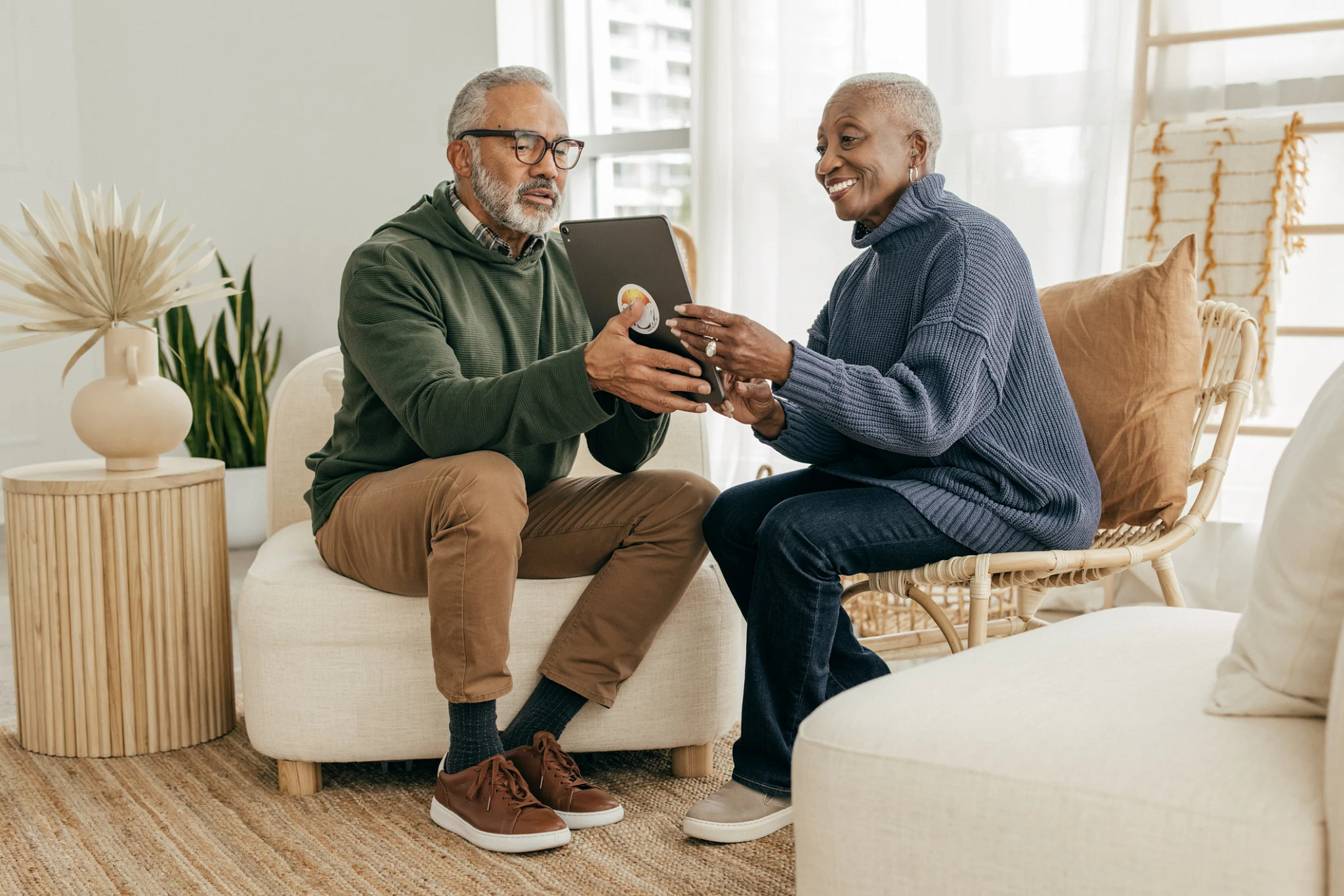 Senior couple at home with tablet