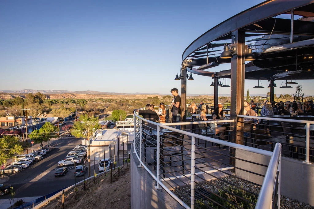 people at a rooftop restaurant overlooking a city