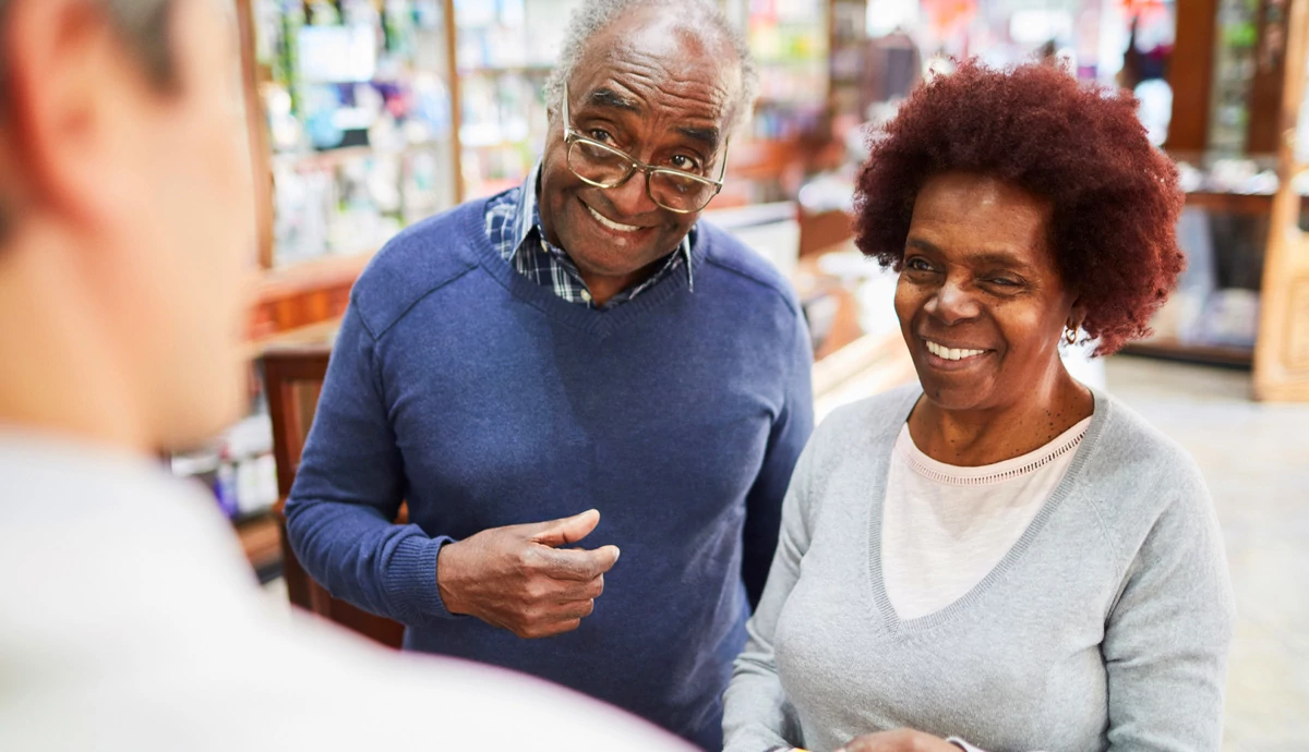 Couple smiling at pharmacy
