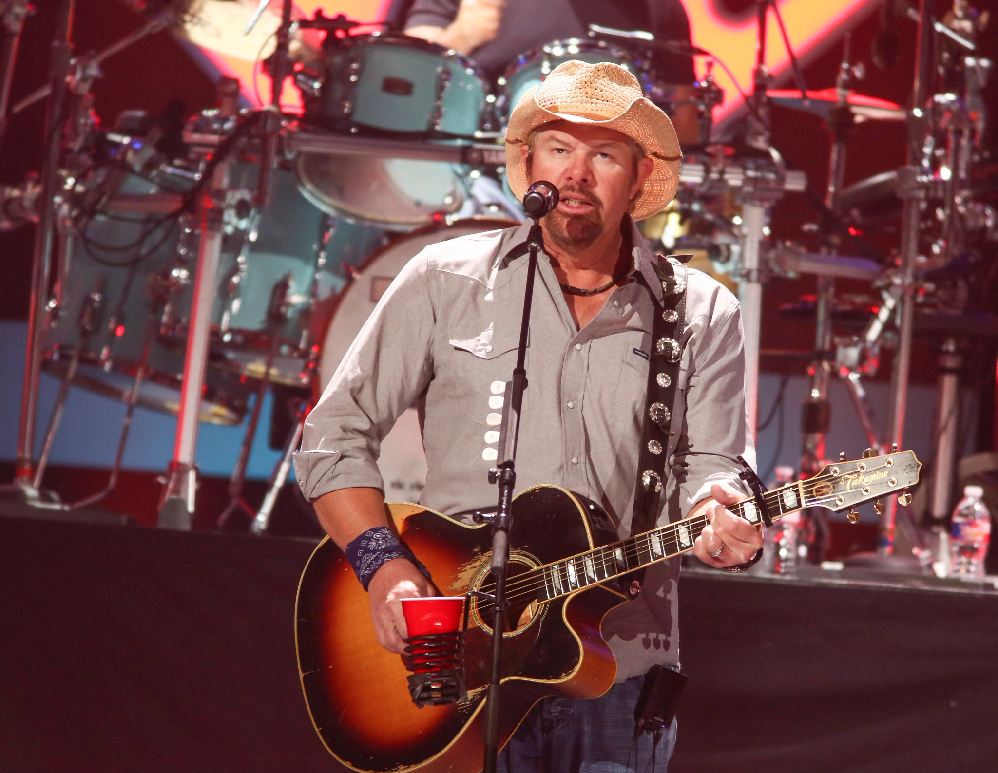Toby Keith playing his guitar at the iHeartCountry Festival at the Frank Erwin Center in Austin Texas