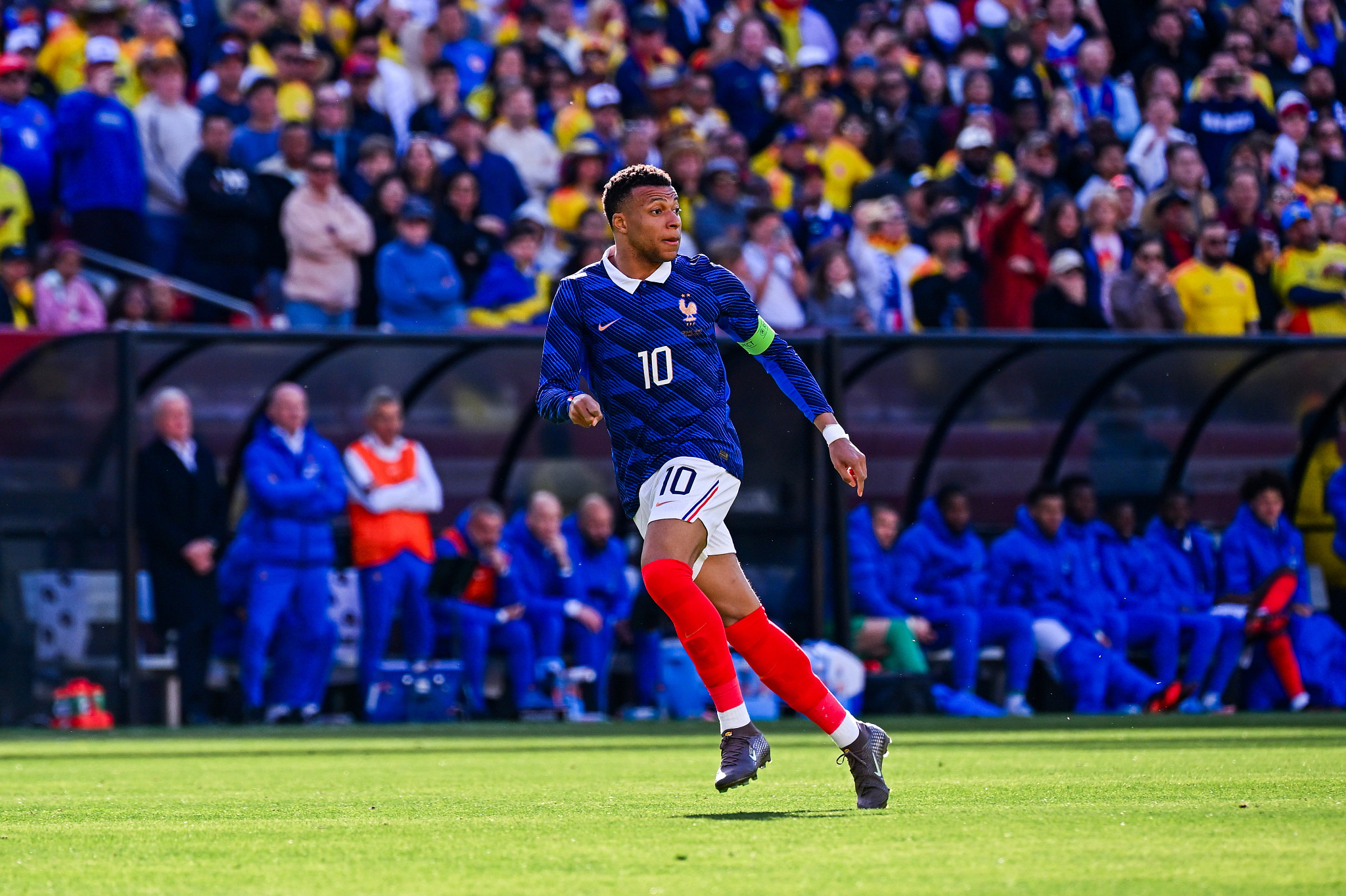 kylian mbappé running with an alert expression during a soccer match