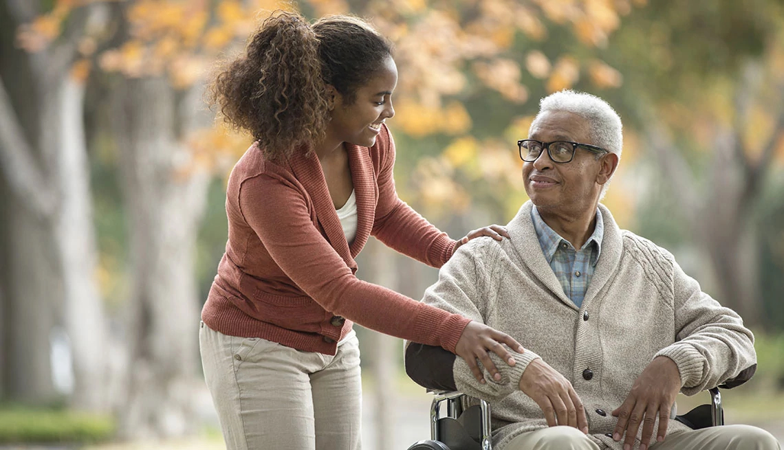AARP Family Caregiving Guides african american older man in wheelchair with teenage african american girl outside