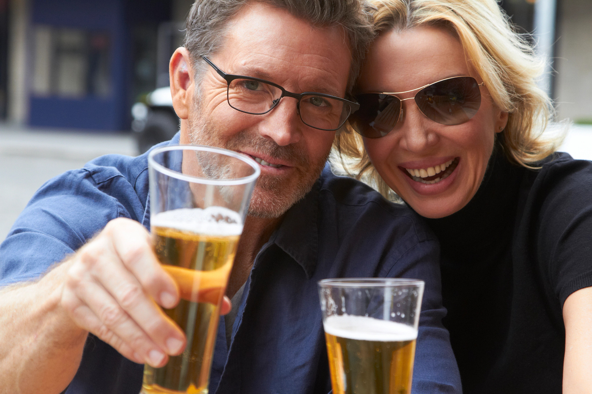 Caucasian couple drinking beer outdoors