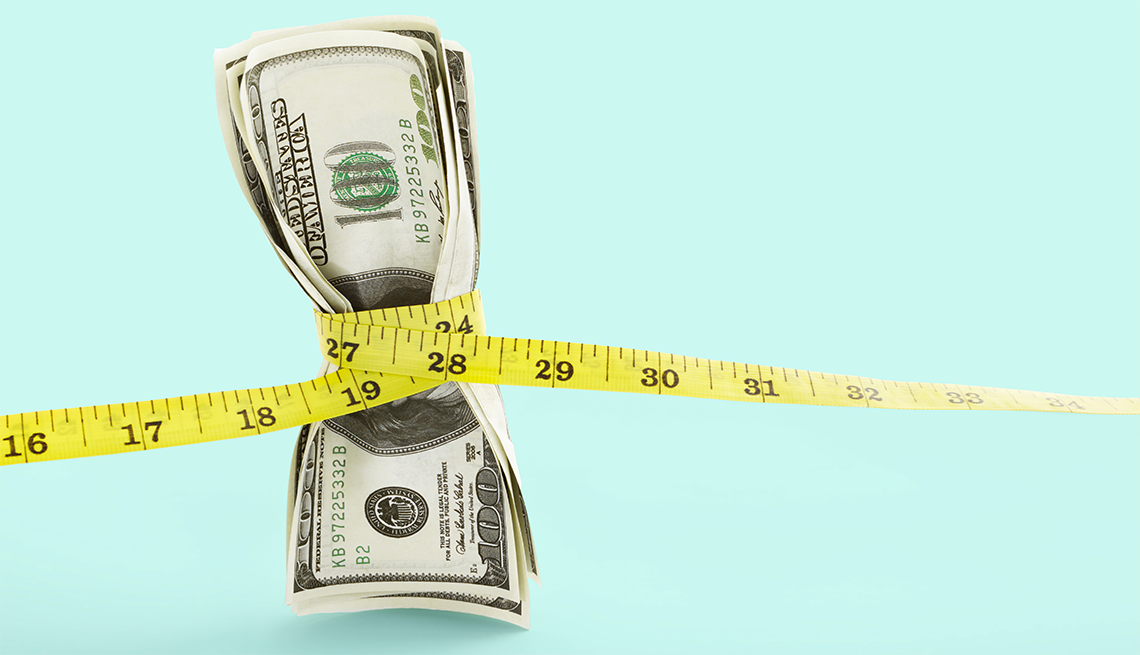 Go on a Money Diet hundred dollar bills cinched with a measuring tape