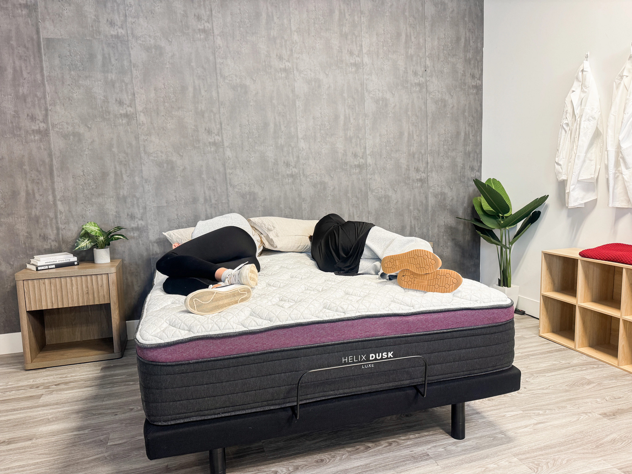 Two people lying on the Helix Dusk Luxe mattress.