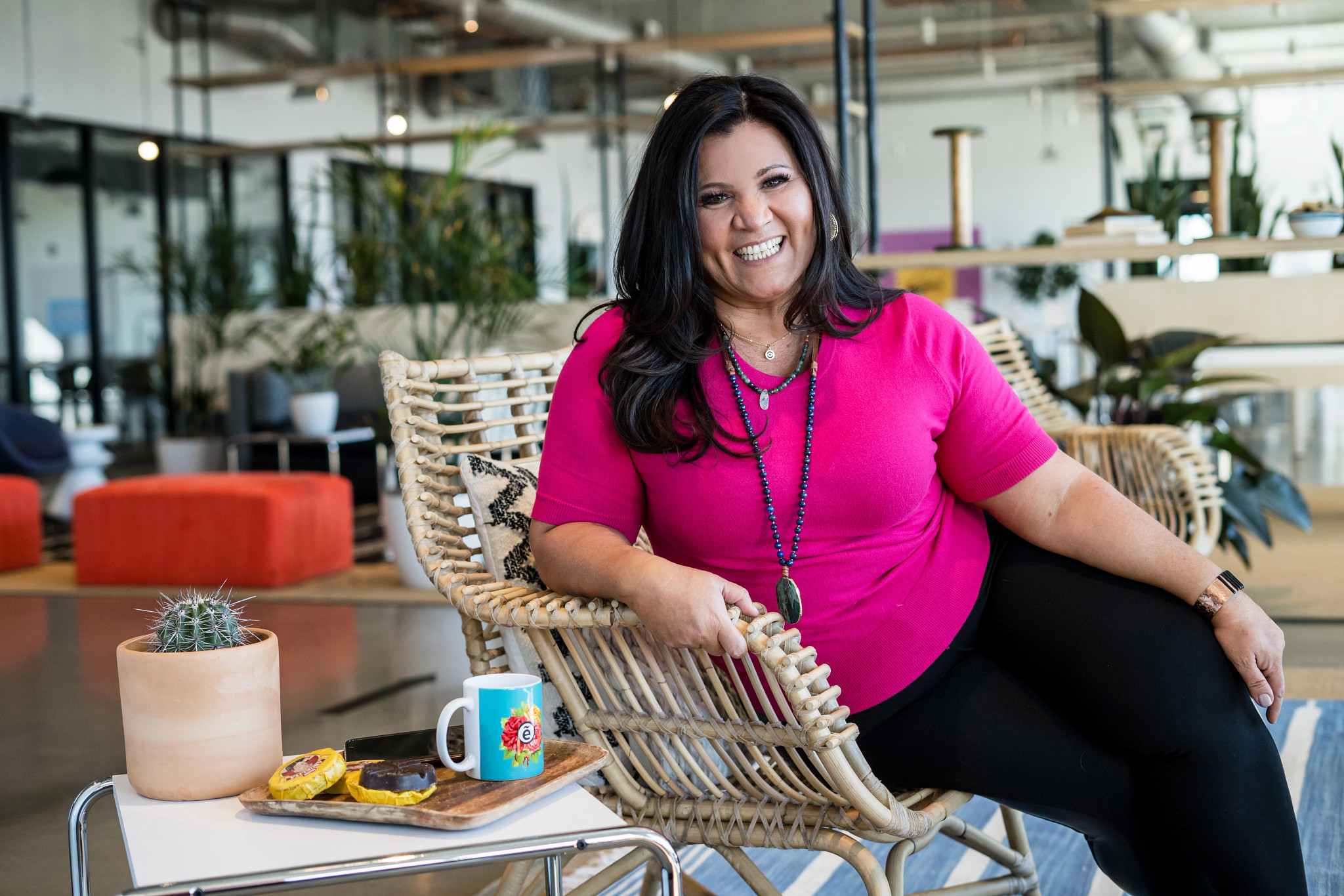 A photo shows author and filmmaker Denise Soler Cox relaxing in a wicker chair
