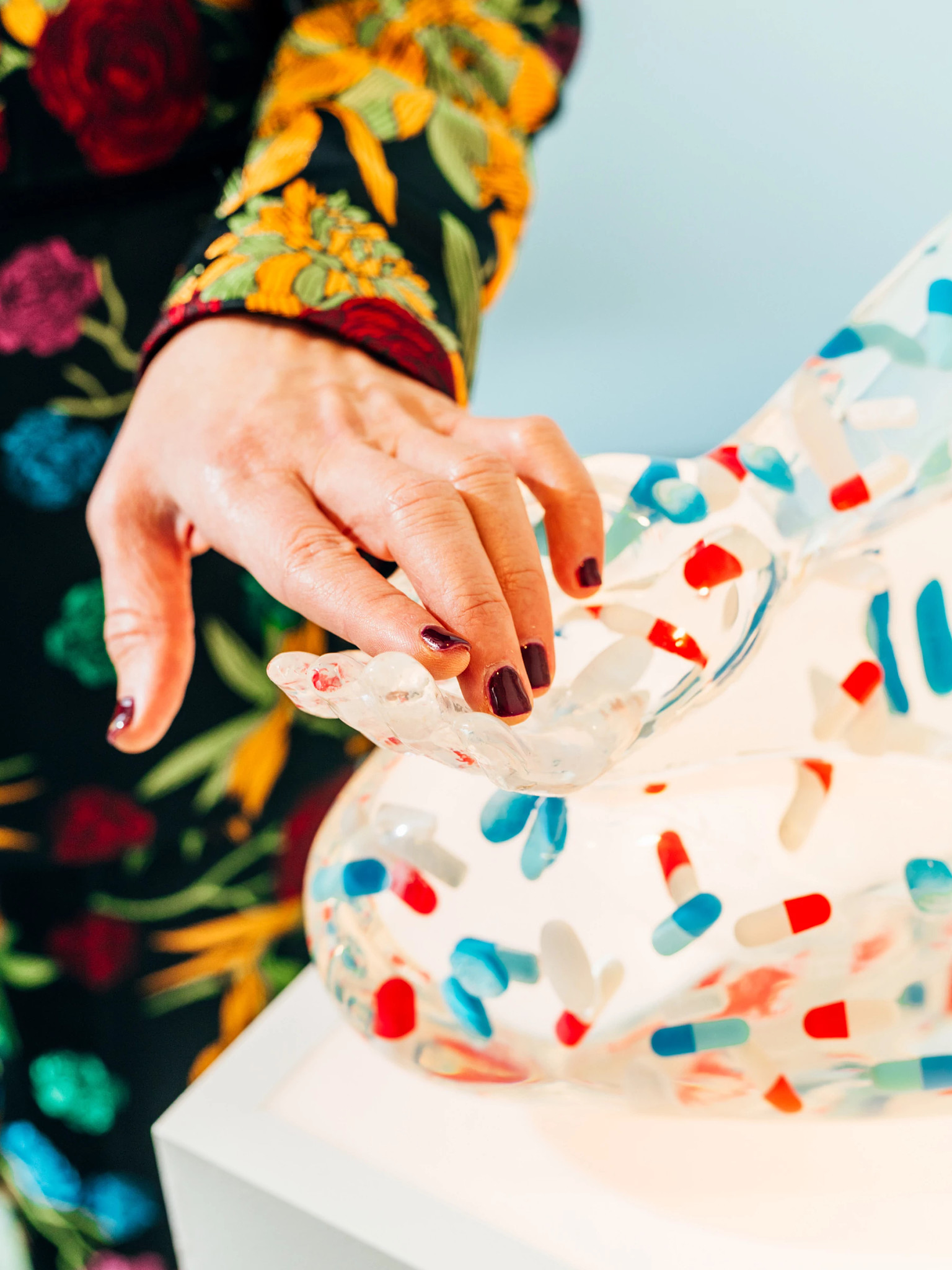 Jewel's hand touching hand of sculpture