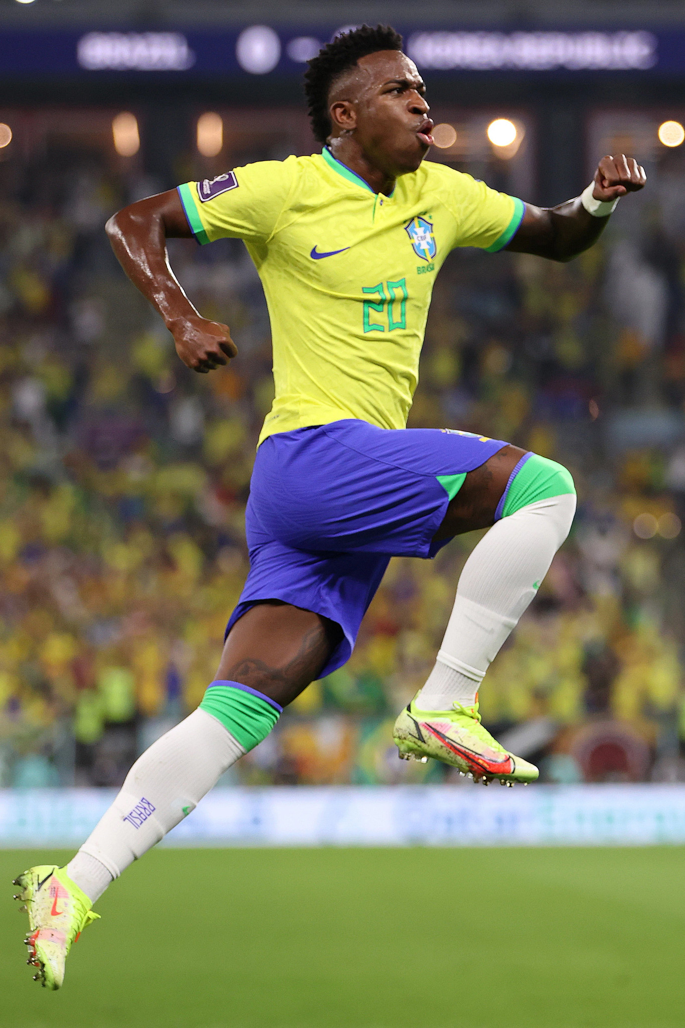 vincius junior striking a dramatic pose in celebration during a soccer game