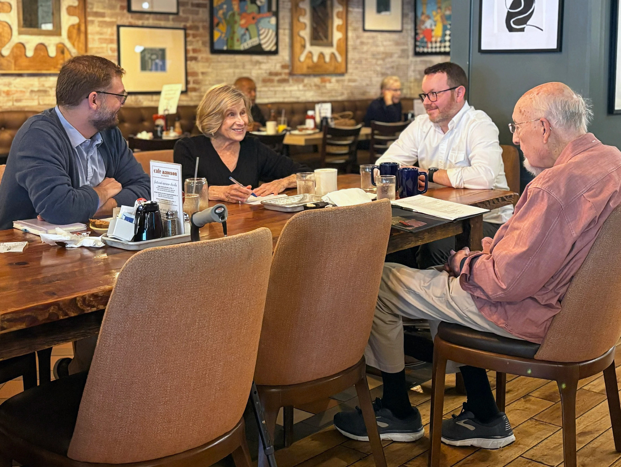 a group of people sitting at a restaurant table