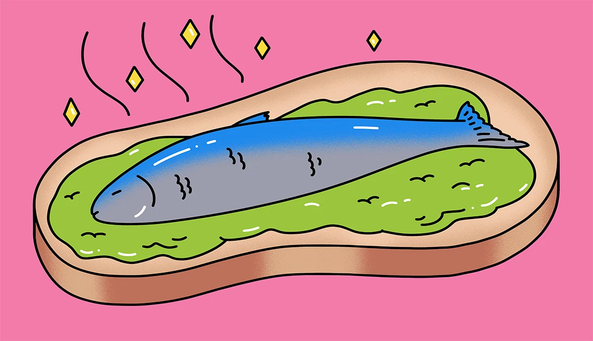 A whole fish served over avocado spread on a slice of toast.