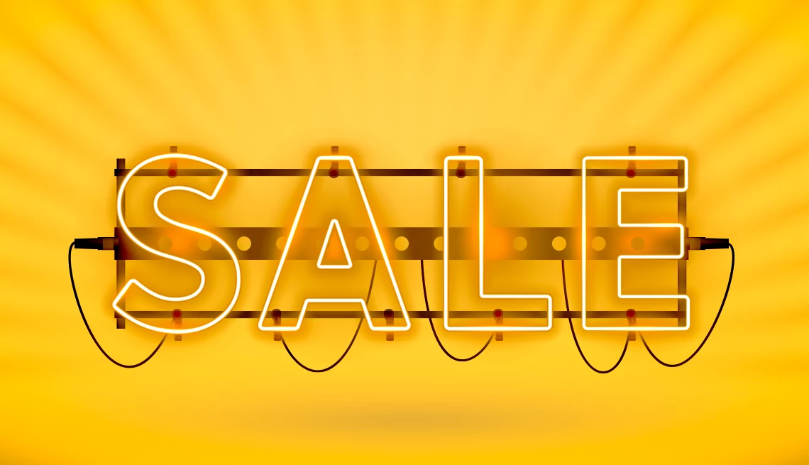 amazon prime day tips a neon sale sign on a gold background