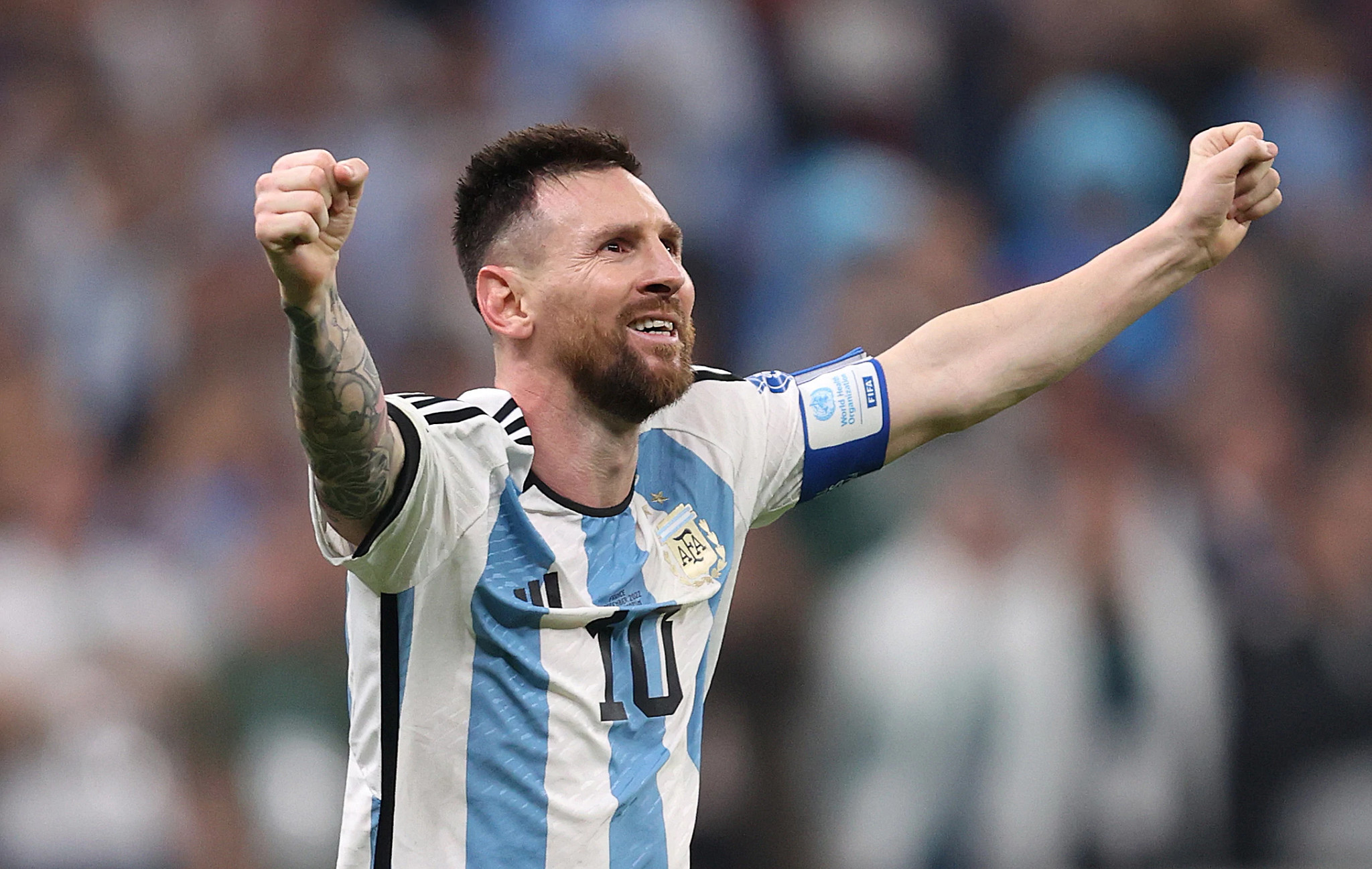 lionel messi raising two fists in celebration during a soccer match