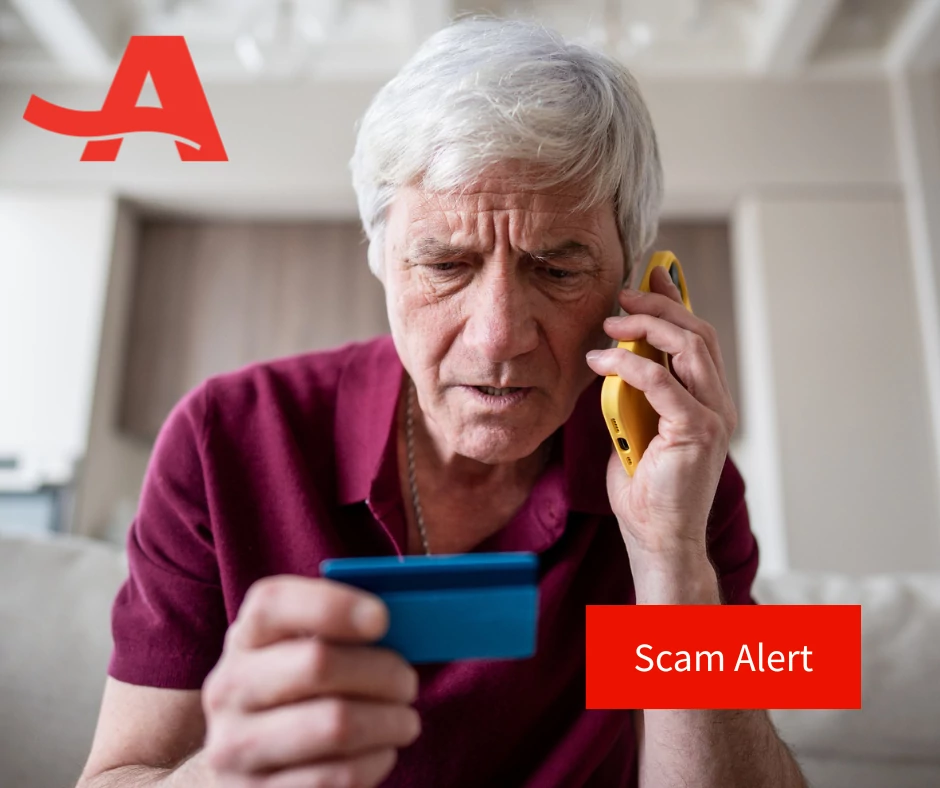 Old man staring in distress at his credit card