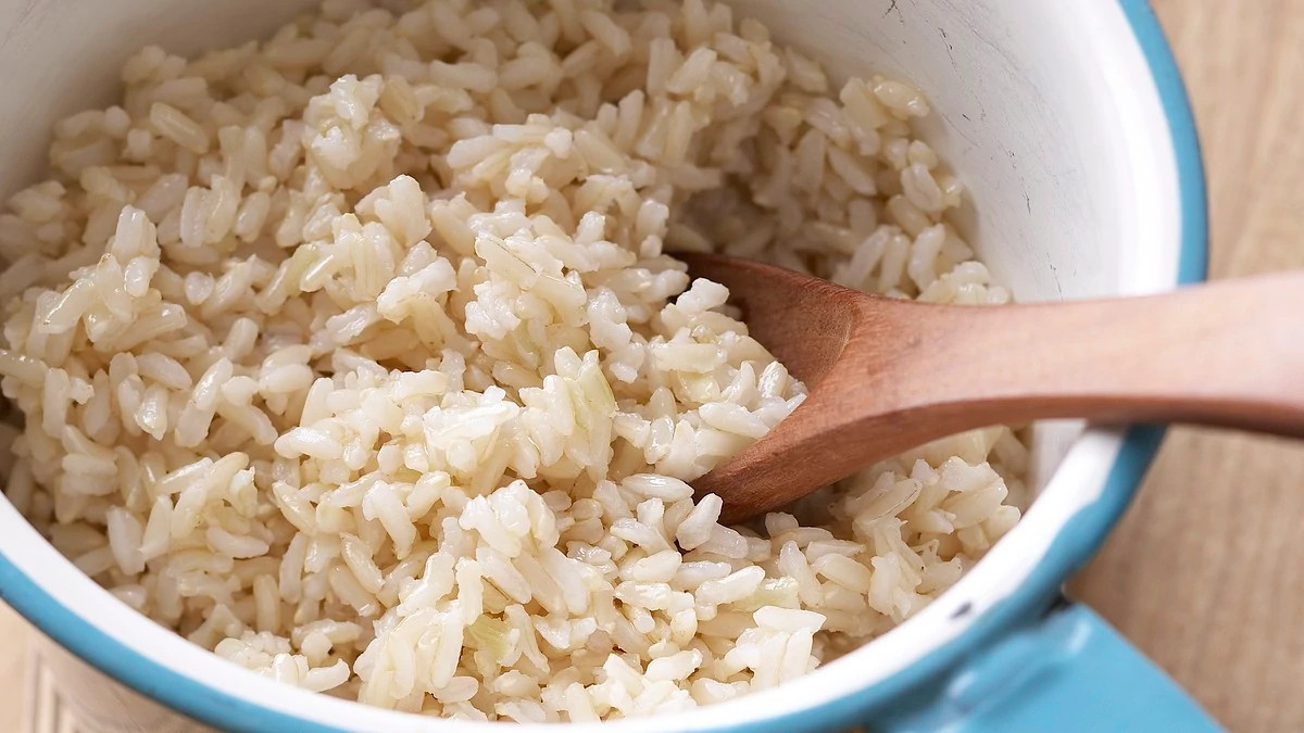 A close-up view of easy brown rice in a bowl with a spoon
