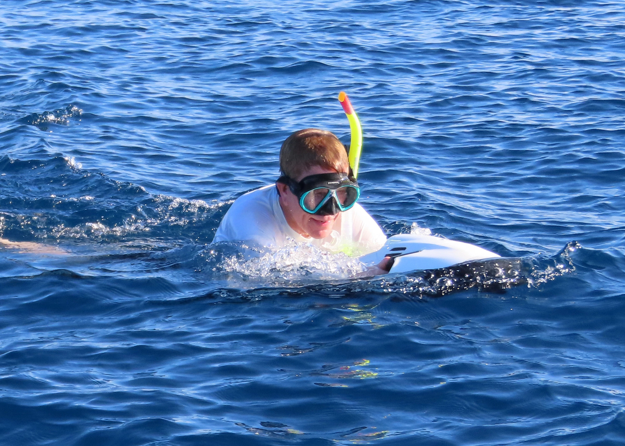 a man wearing scuba gear rides on an underwater Jei Ski