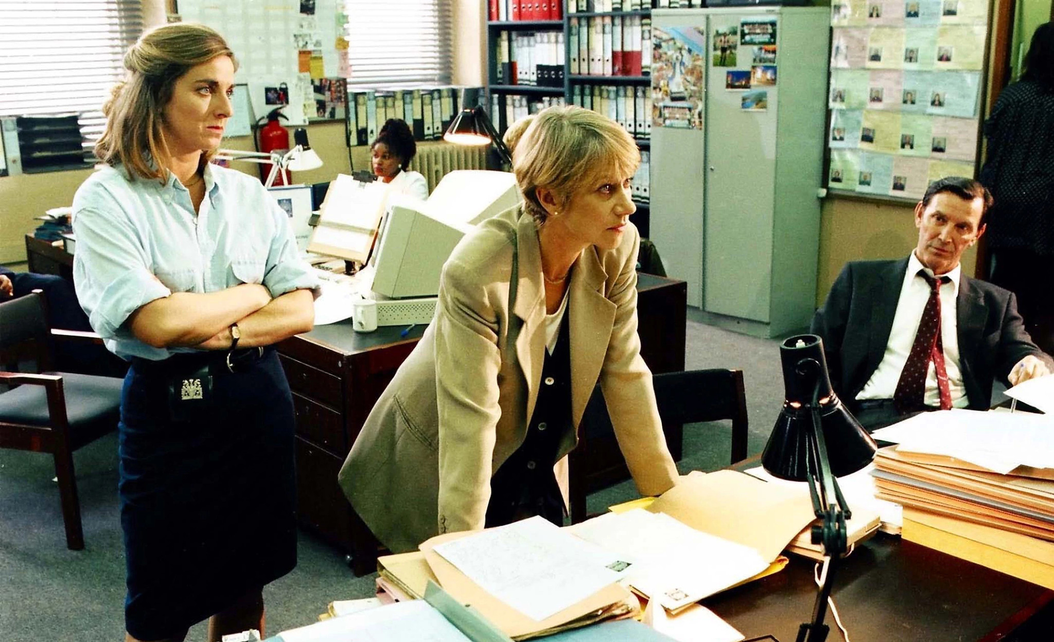 Helen Mirren in Prime Suspect Helen Mirren with her hands placed on a table in a scene from the television miniseries Prime Suspect