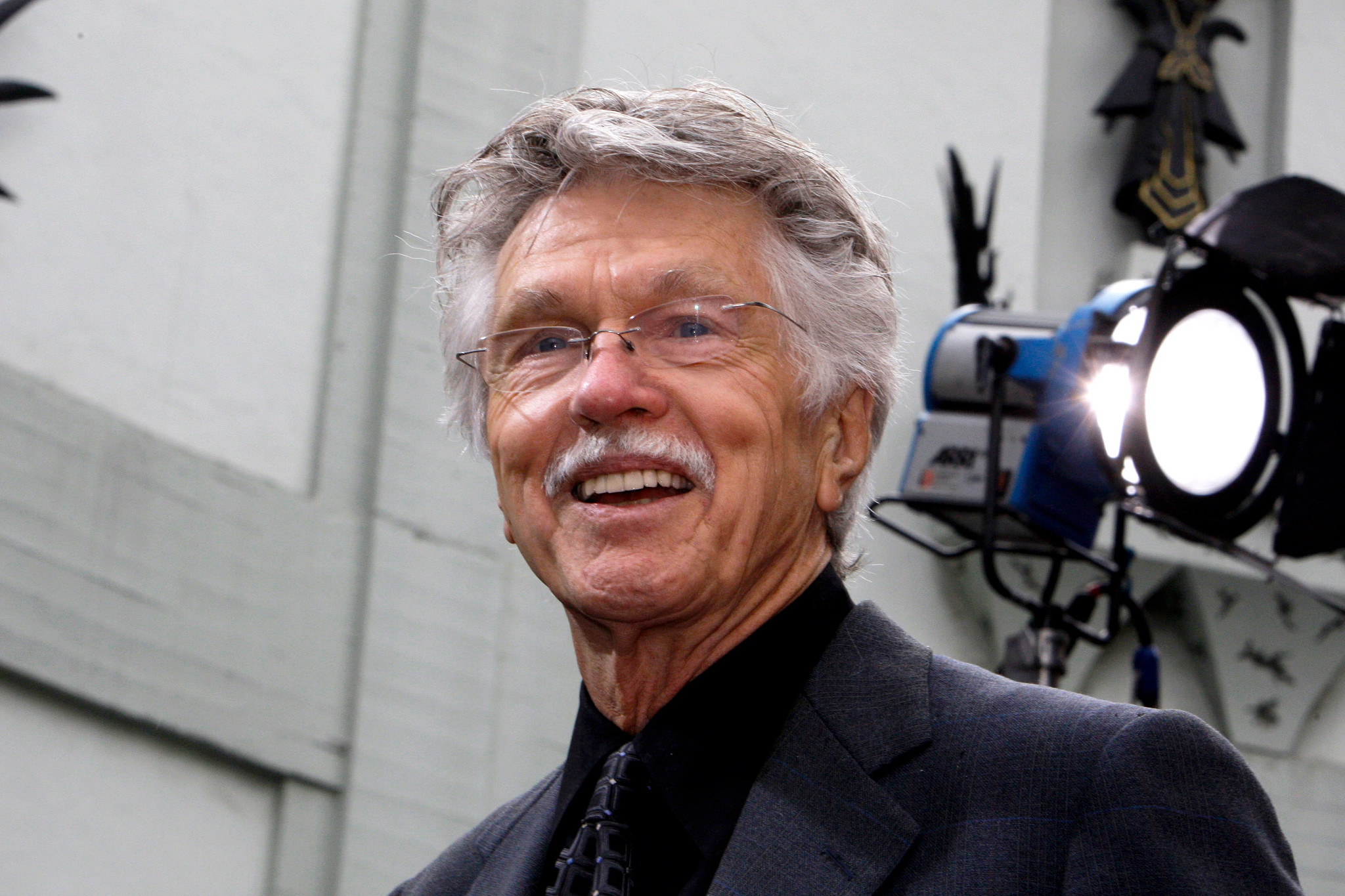 tom skerritt with glasses smiling at a film premiere