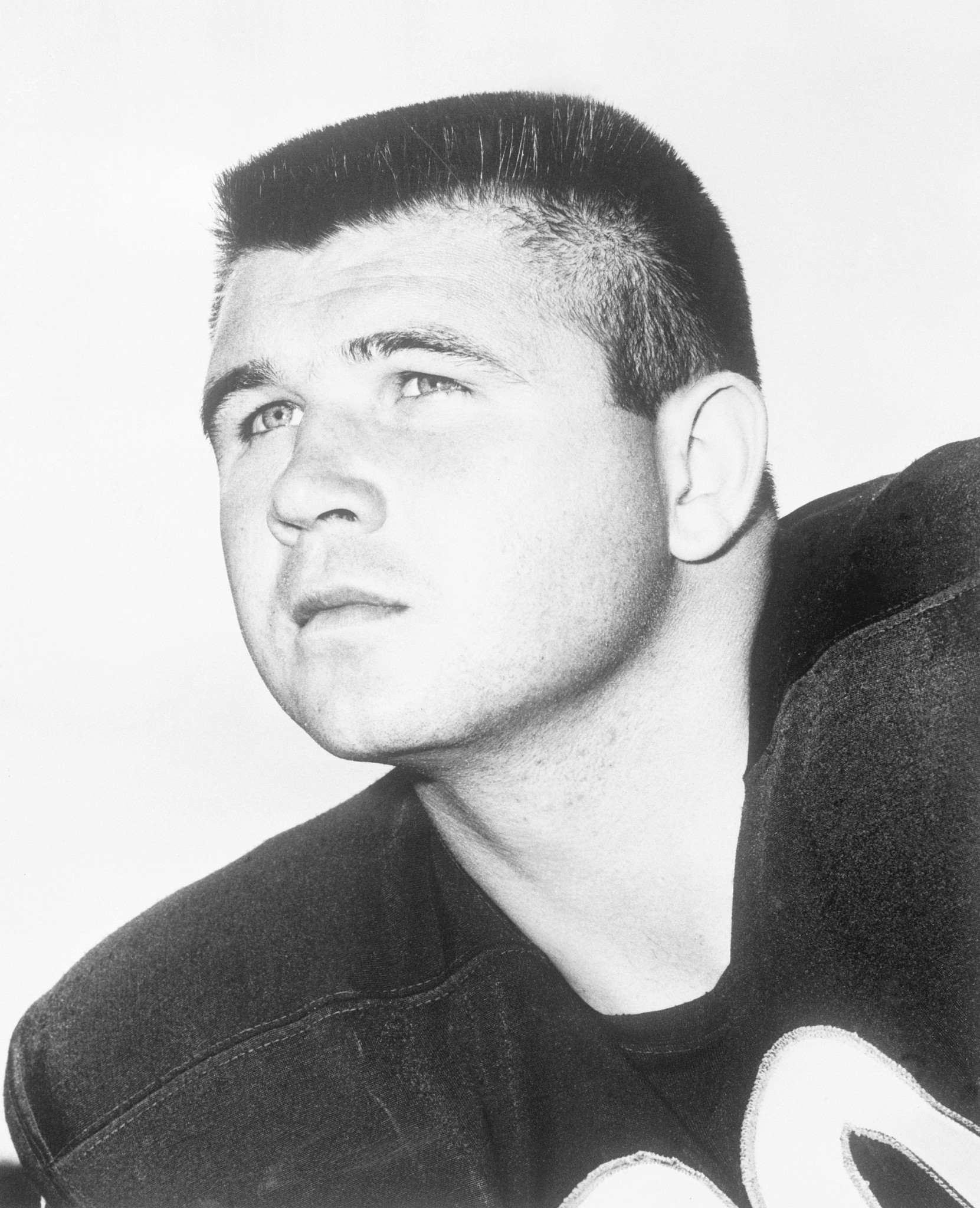 black and white head shot of mike ditka as a young football player