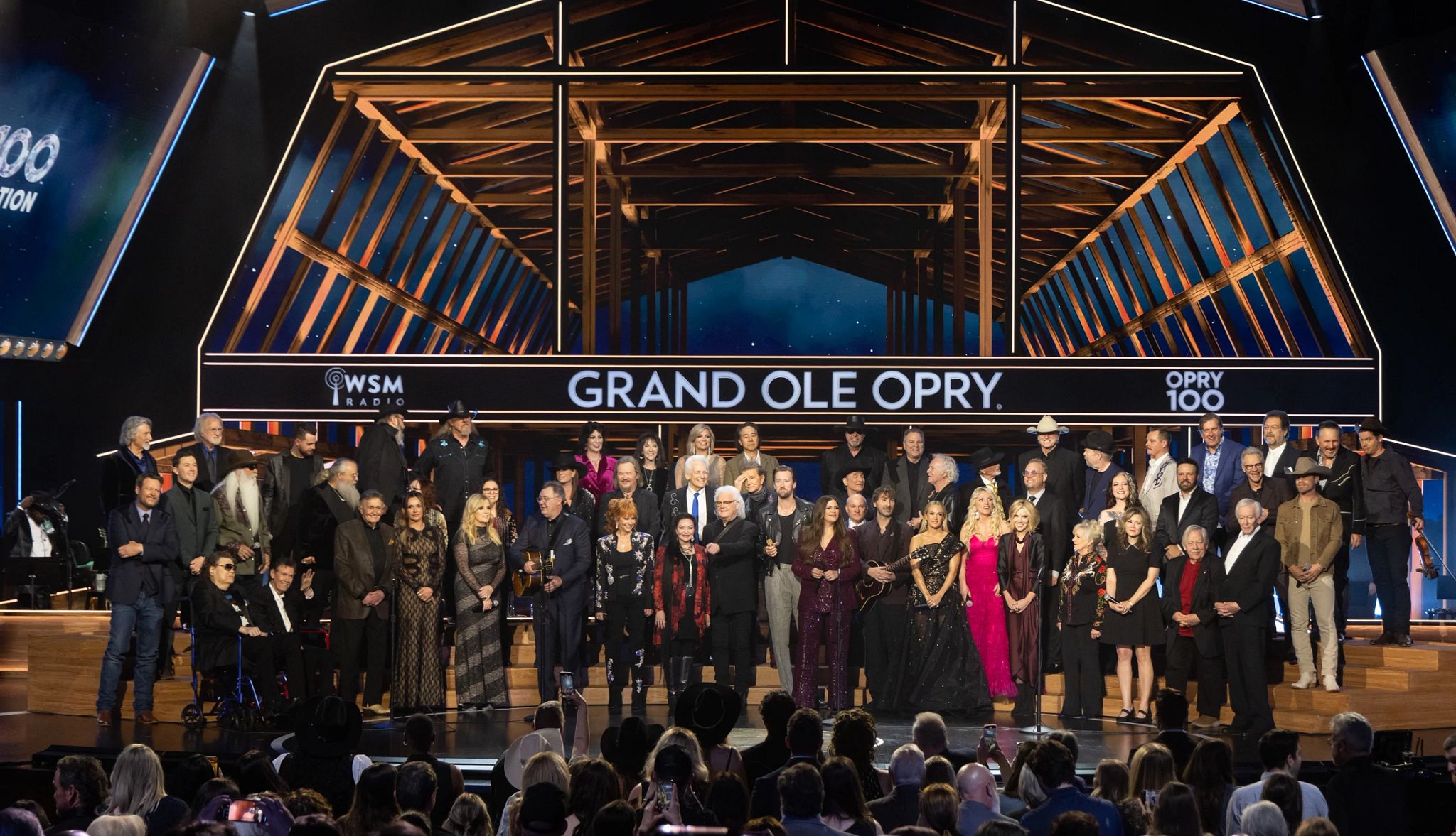 The Grand Ole Opry Celebrates 100 Years people standing on the stage of the grand ole opry