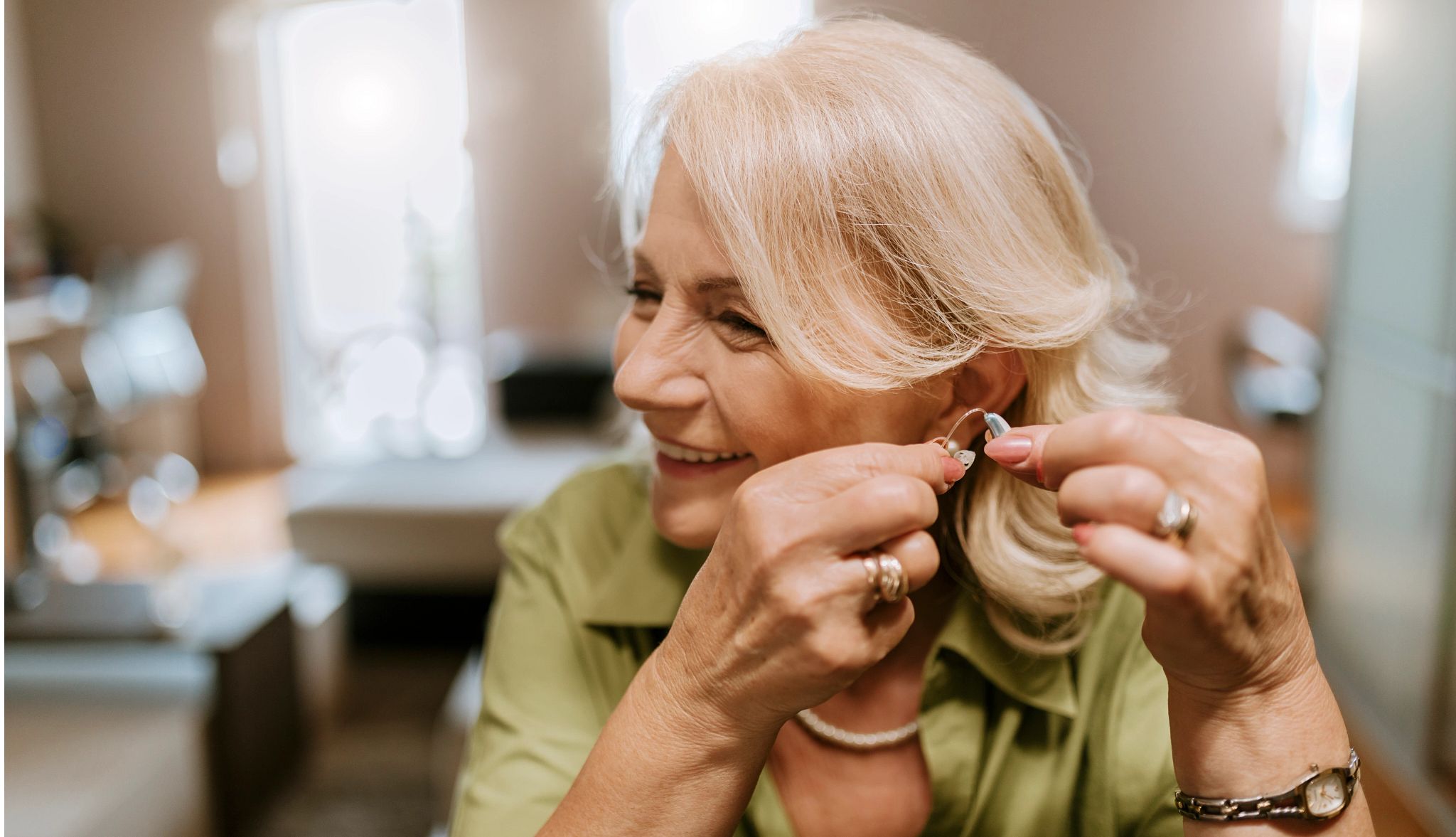 How to Adjust to Hearing Aids woman putting in hearing aid