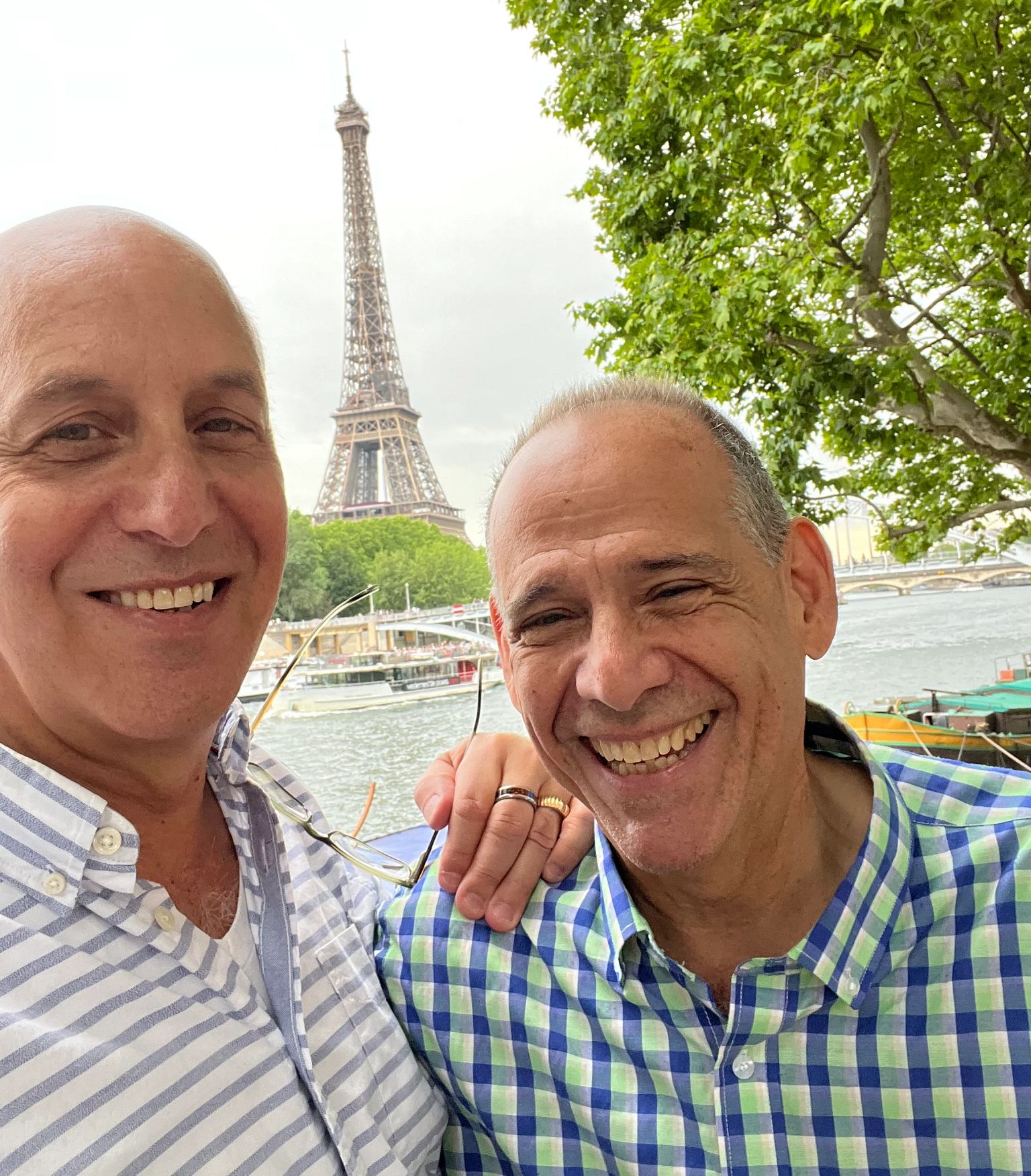 Retirementmoon two men standing next to each other and smiling with the eiffel tower in the background