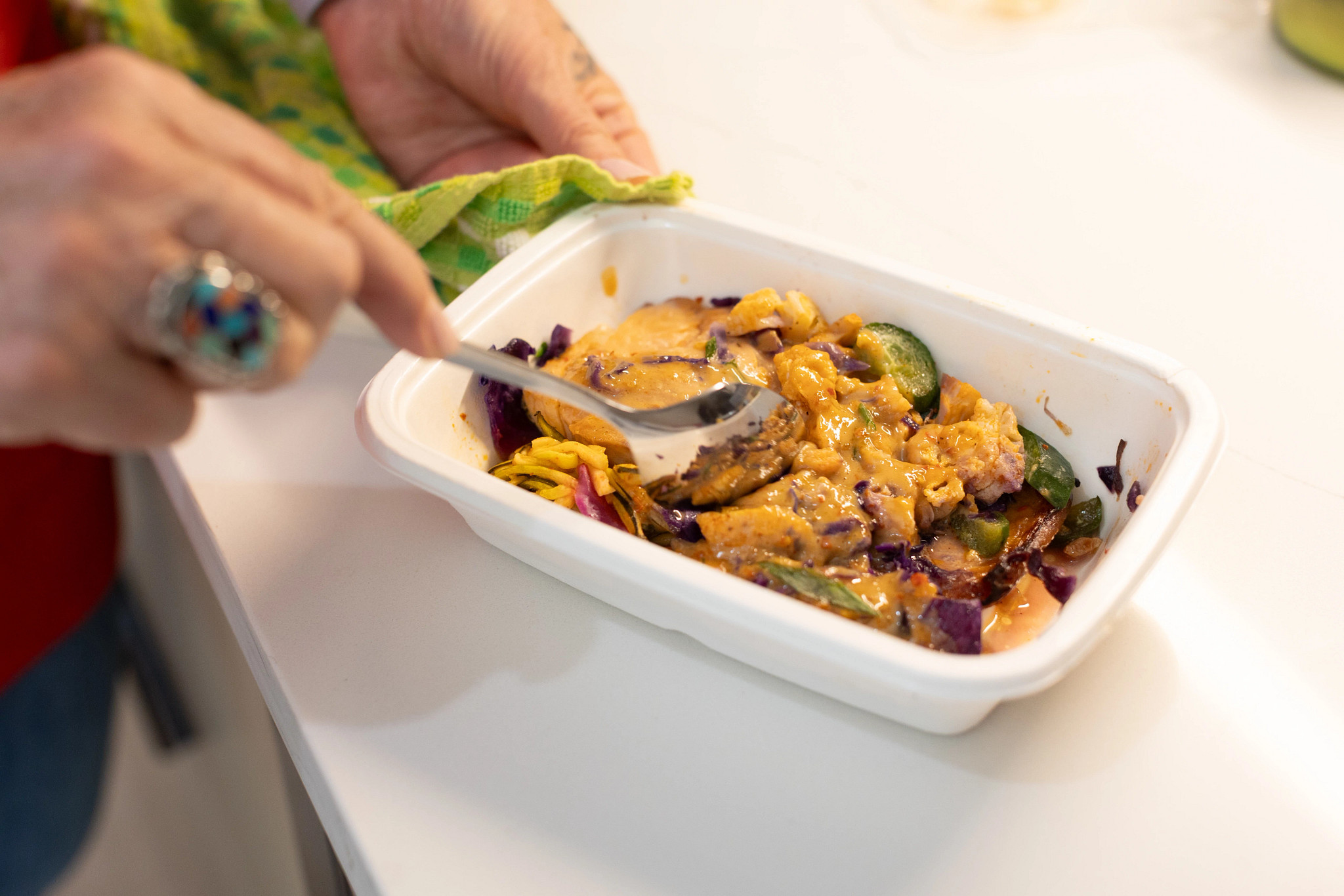 An older adult unpacking a CookUnity meal delivery service bag