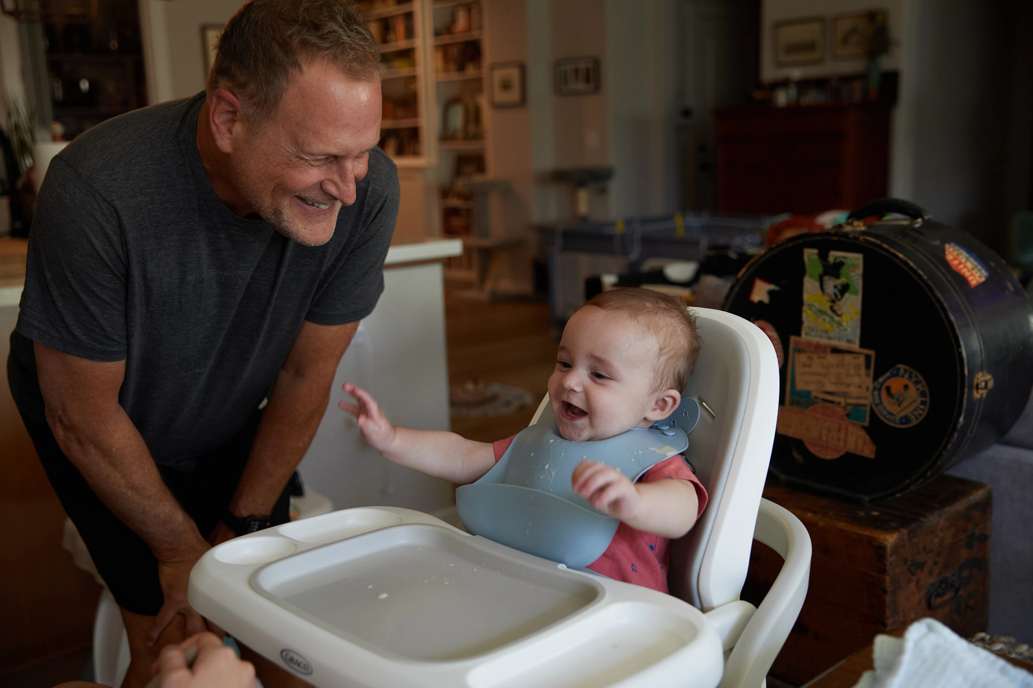 dave coulier smiling with his infant grandson