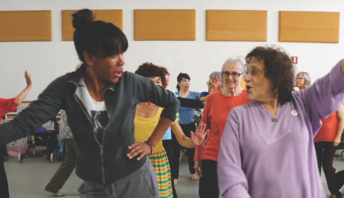 Arts and aesthetic experiences may change the body, brain and behavior Two women dancing in a room in front of other women