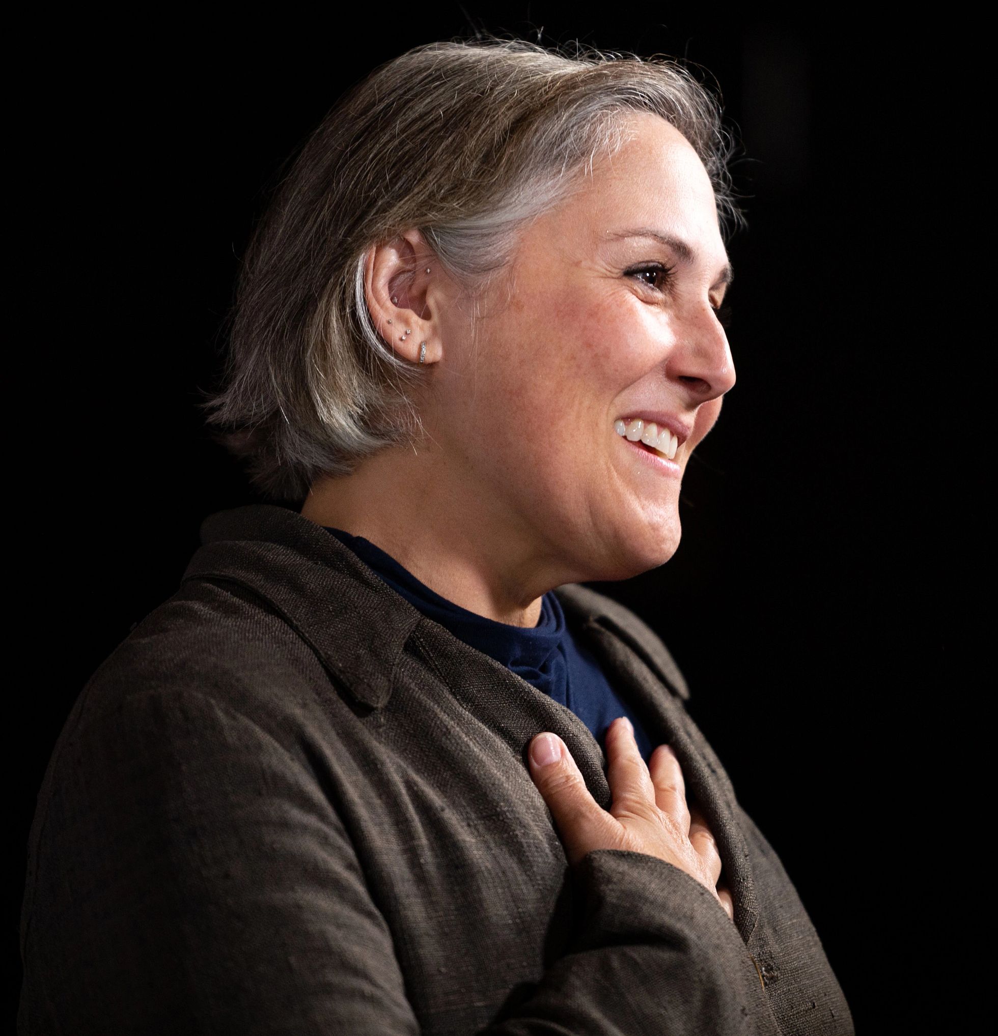 Ricki Lake Debuts Facelift After Major Weight Loss ricki lake smiling in profile, holding her hand against her chest