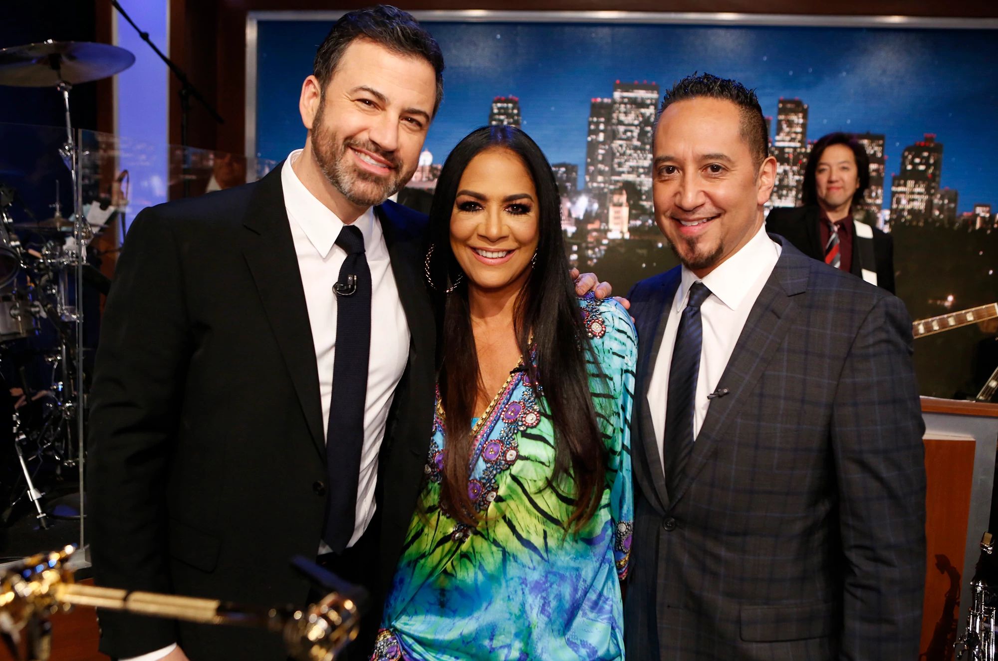 Cleto Escobedo III, Jimmy Kimmel’s Bandleader, Dies jimmy kimmel, left, sheila e and cleto escobedo standing and smiling together