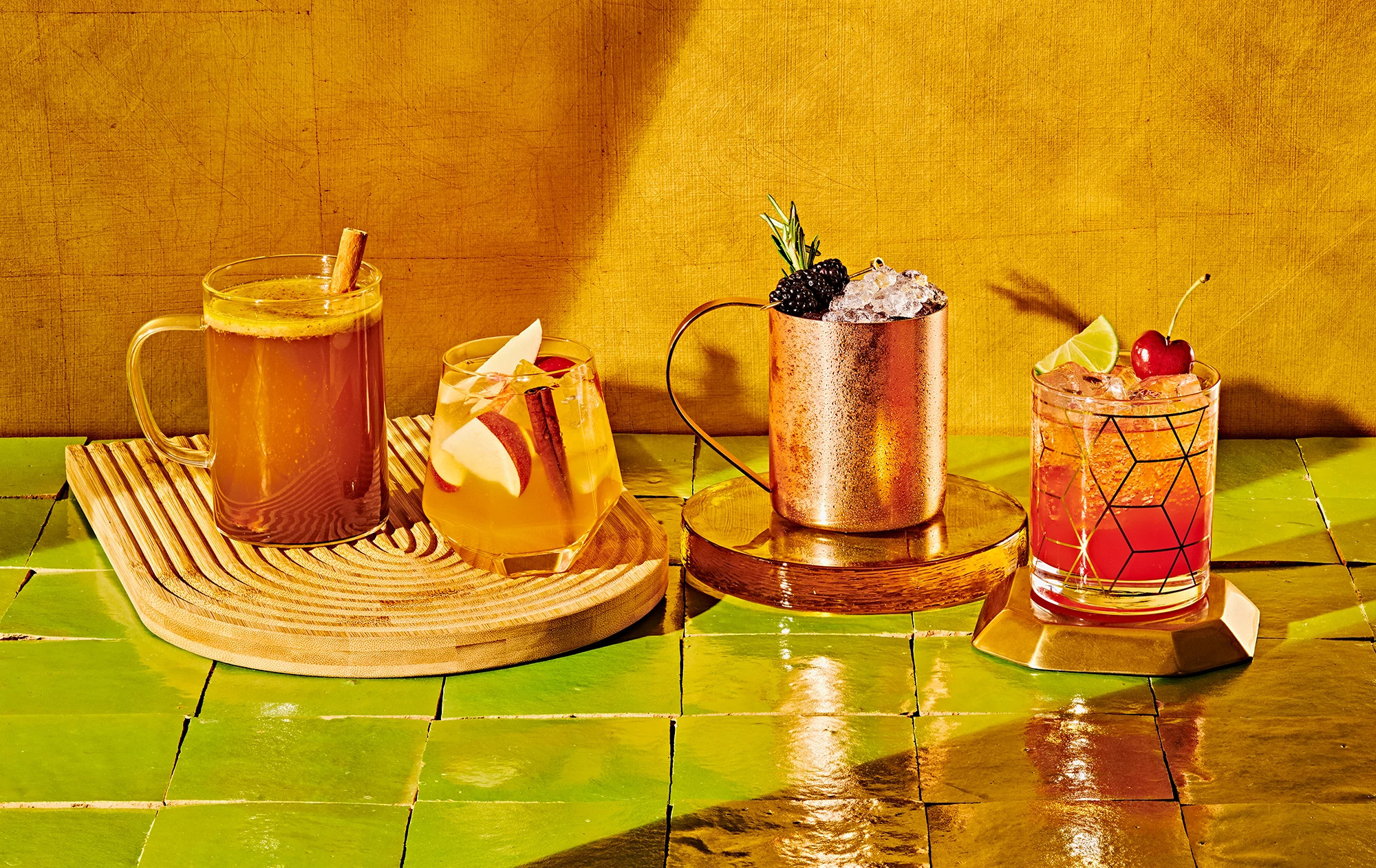 Shirley Ginger, Roseberry Mule , Chai Hot Buttered Rum and Apple & Ginger ale Spritzer on a table