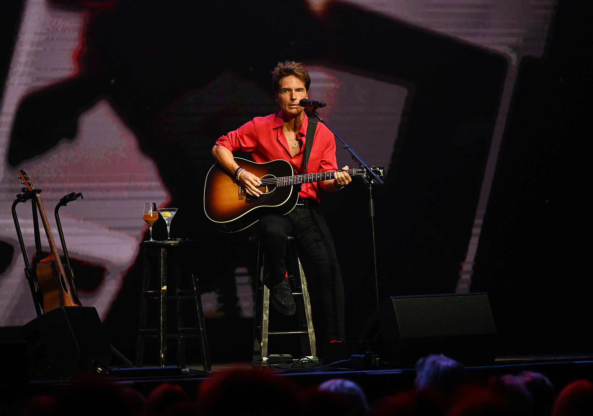 The resonant tones of a guitar fill the air, accompanied by the soulful voice of Richard Marx