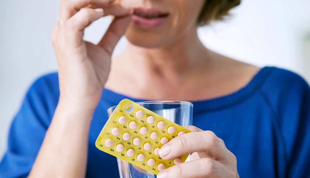 Hormonal changes may affect your thinking A woman putting a pill into her mouth