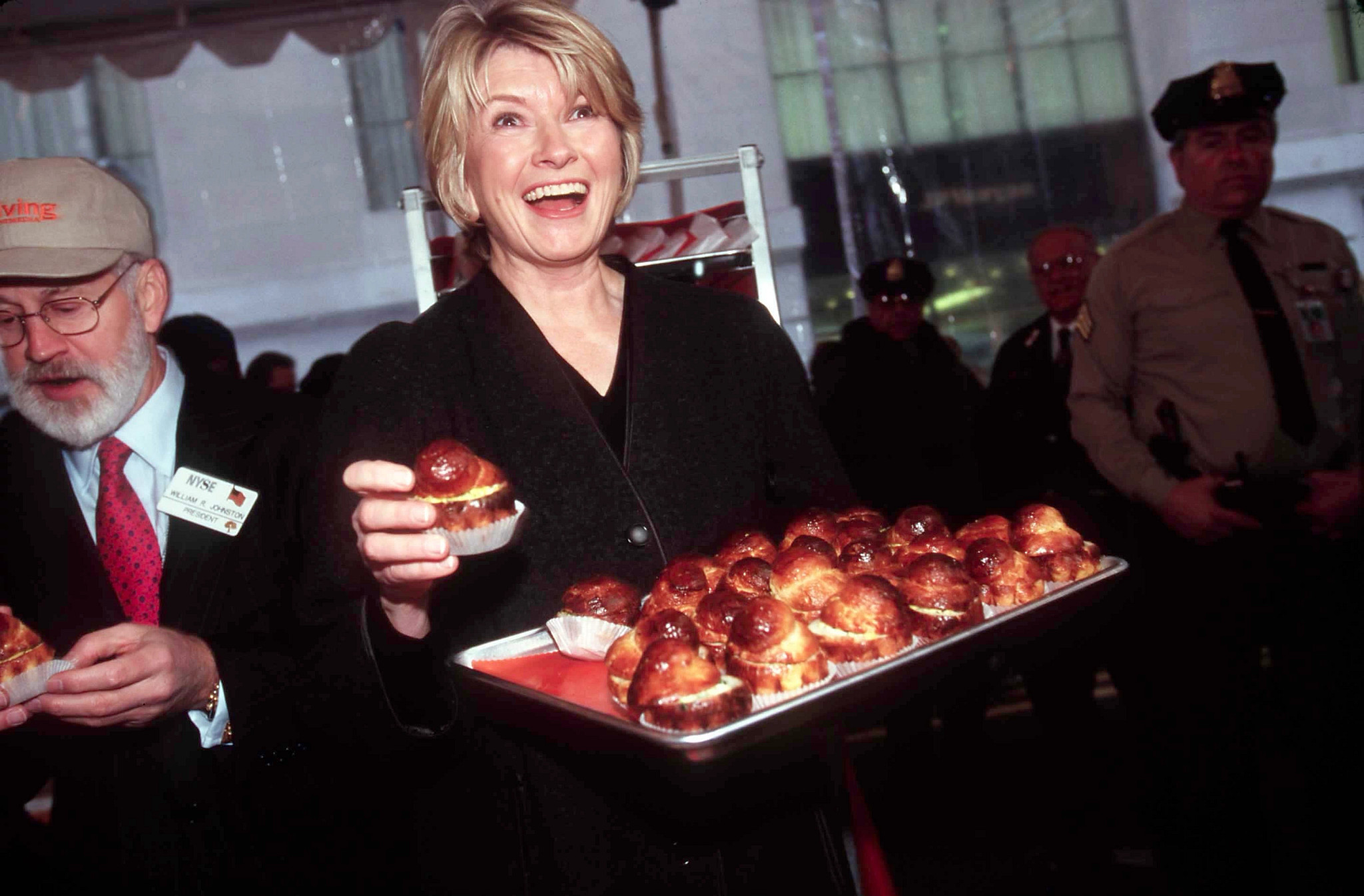 A photo shows Martha Stewart brandishing a tray of cinnamon rolls at the New York Stock Exchange in 1989.