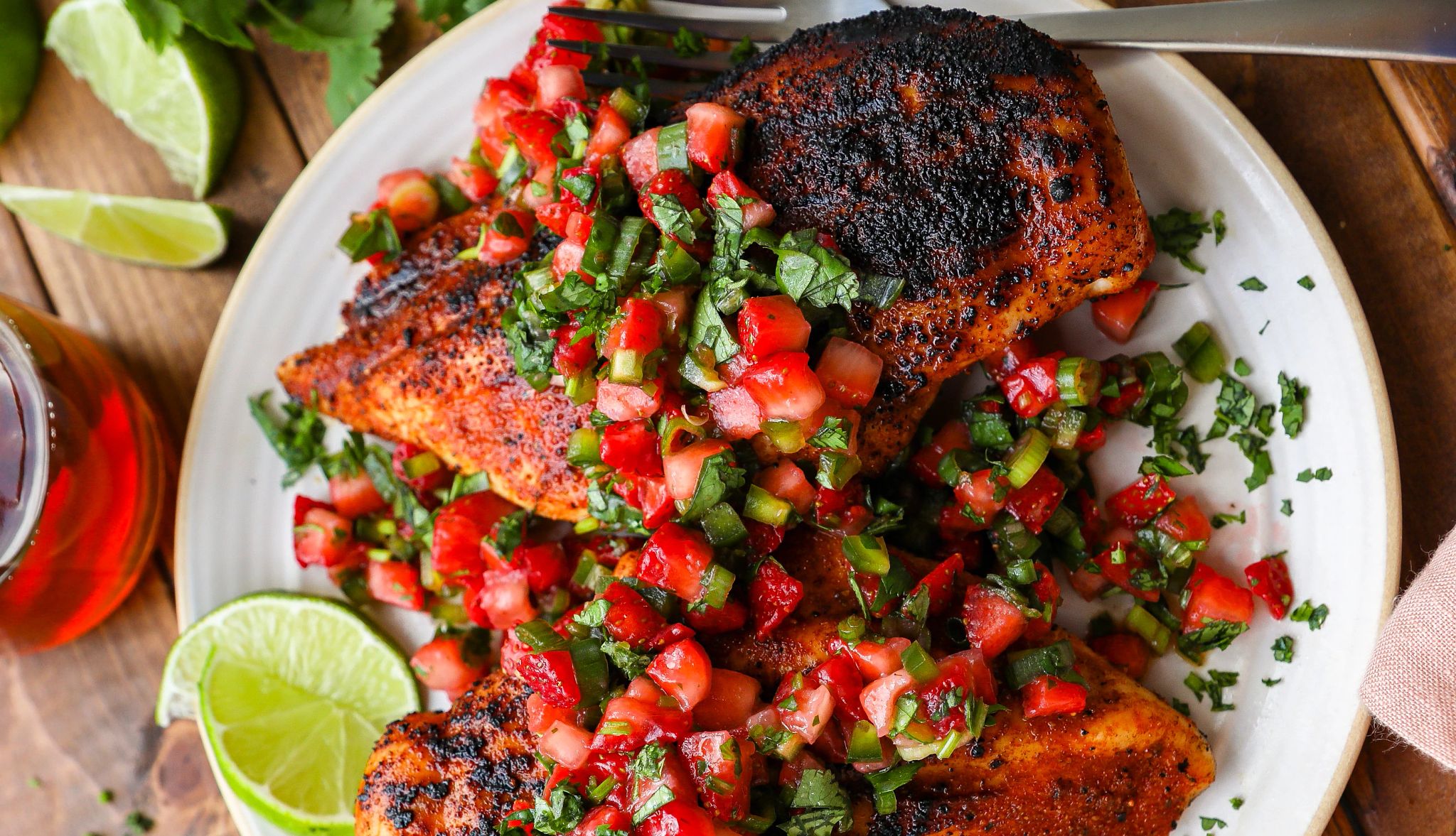 Grilled chicken with strawberry-jalapeño salsa Grilled chicken topped with strawberry-jalapeño salsa on plate