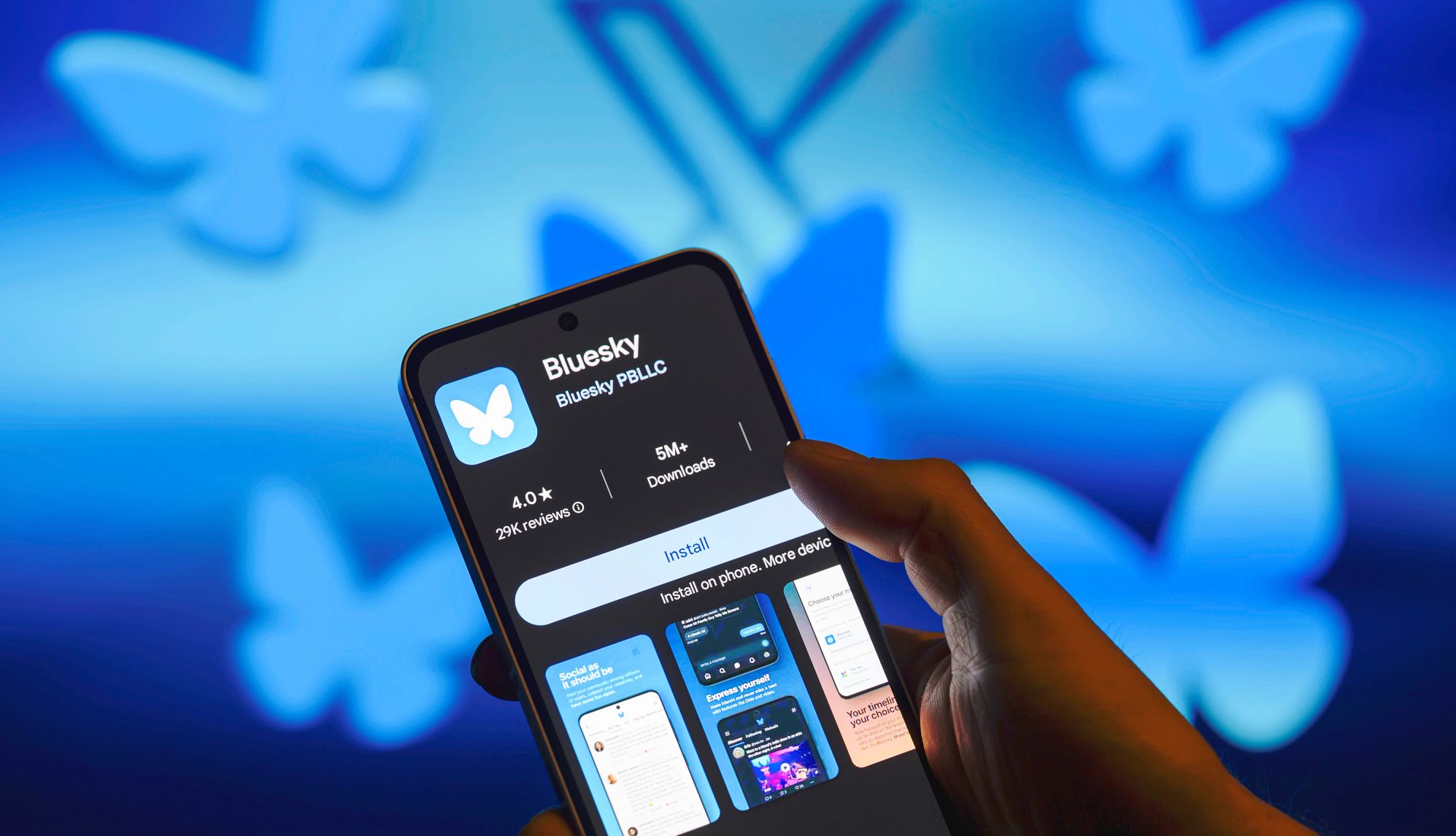 What Older Adults Should Know About Bluesky The Bluesky app logo is displayed on a smartphone with the Bluesky icon together with X visible in the background.