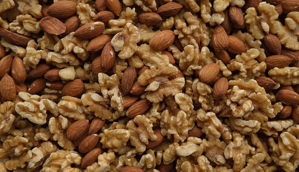 Our brains thrive on a diet that includes nuts and whole grains An overhead view of almonds and walnuts
