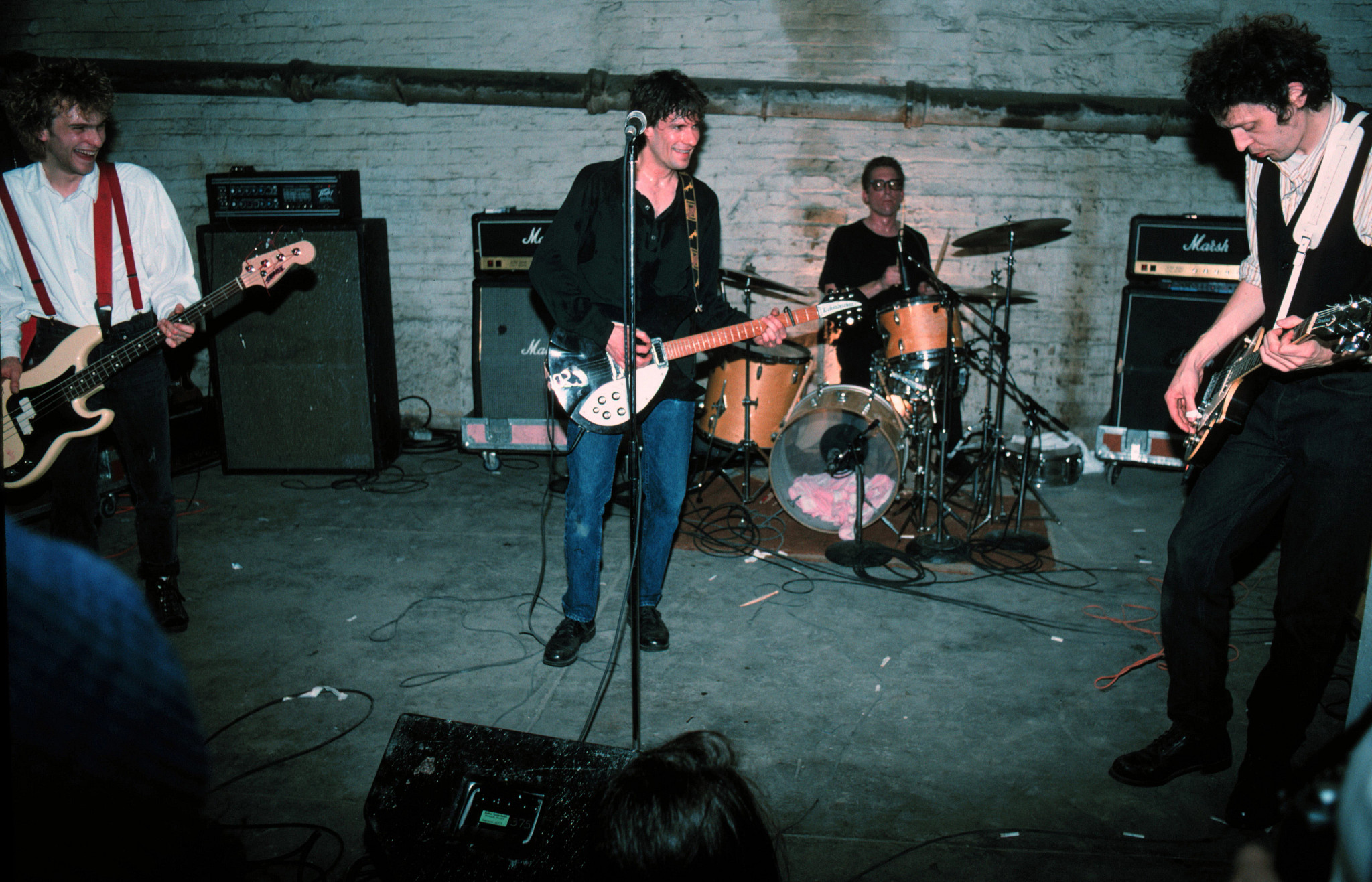 The Replacements performing in a gritty setting.