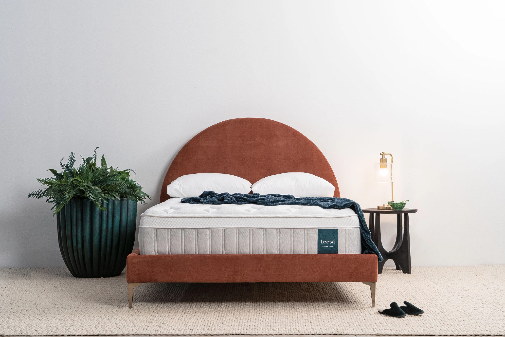 The Leesa Sapira Chill mattress with a plant and lamp on either side of the bed