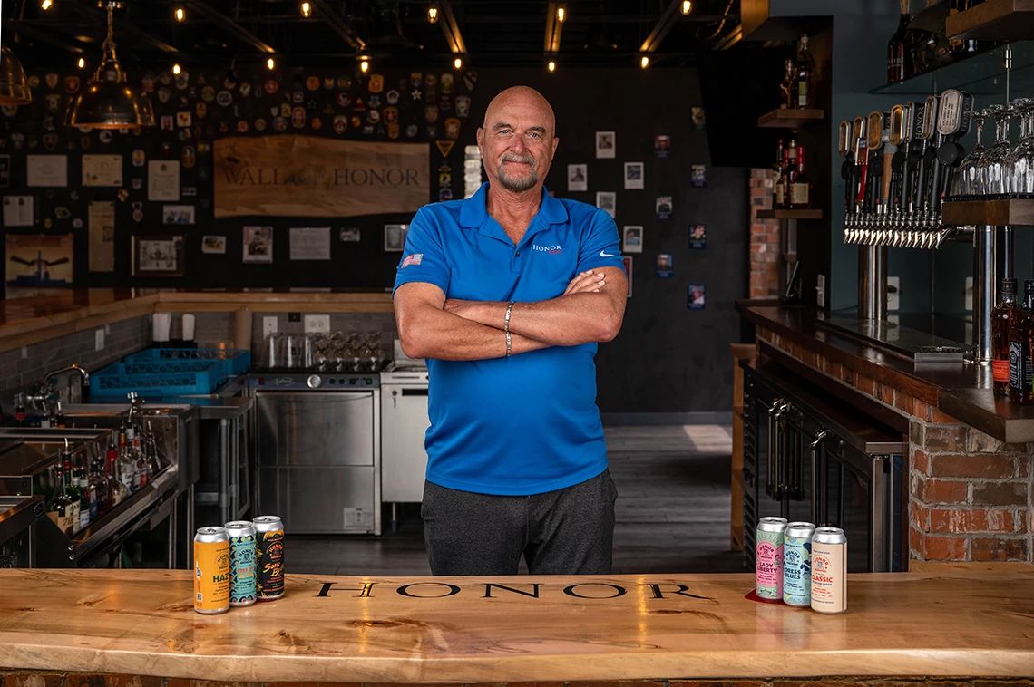 Veteran-Owned Distilleries and Breweries a man stands behind a bar at honor brewing