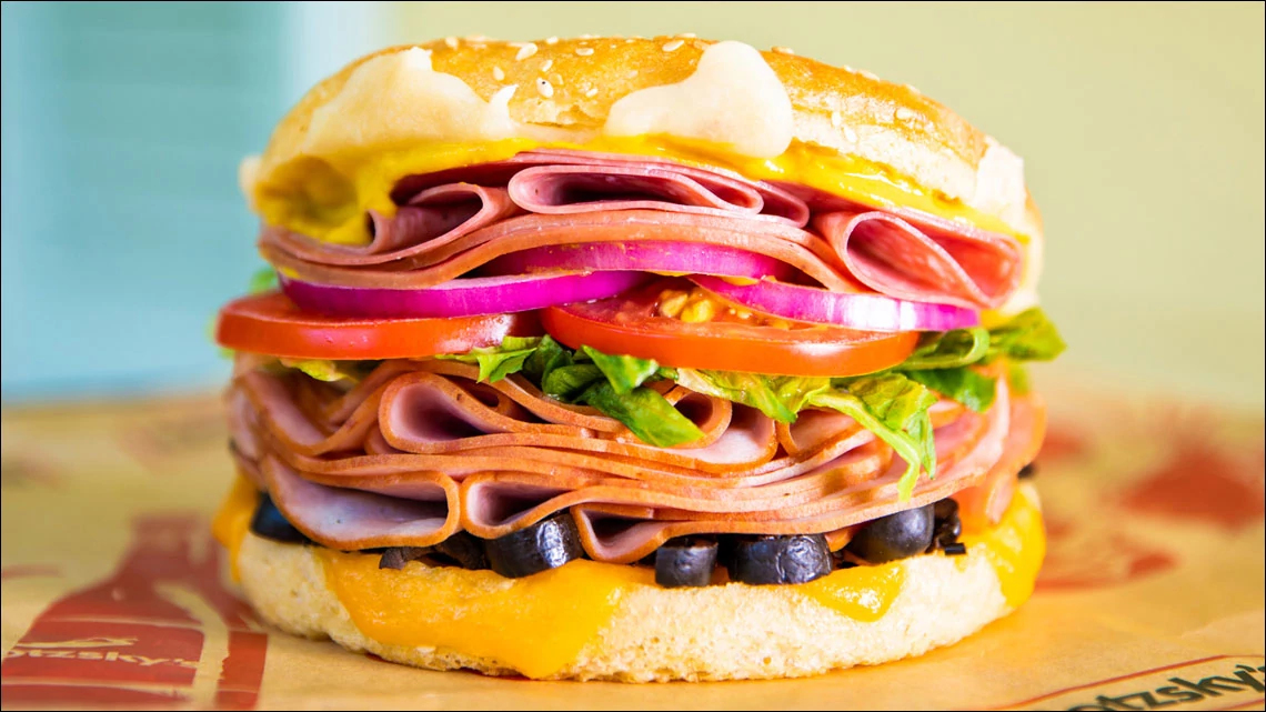 Schlotzsky’s ham turkey red onion tomato lettuce black olives mustard on white roll
