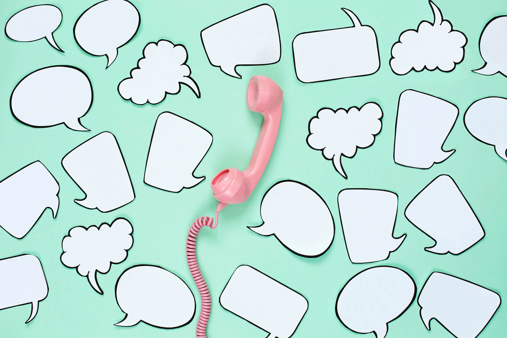 Pink phone used to stay in touch with friends surrounded by speech bubbles.
