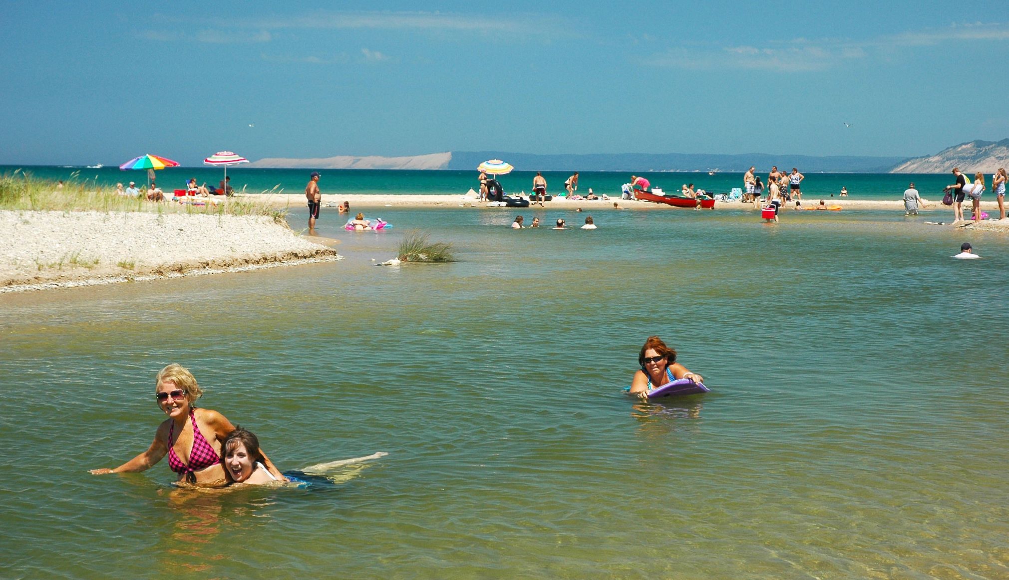 Multigenerational Trips people playing in shallow water at a beach