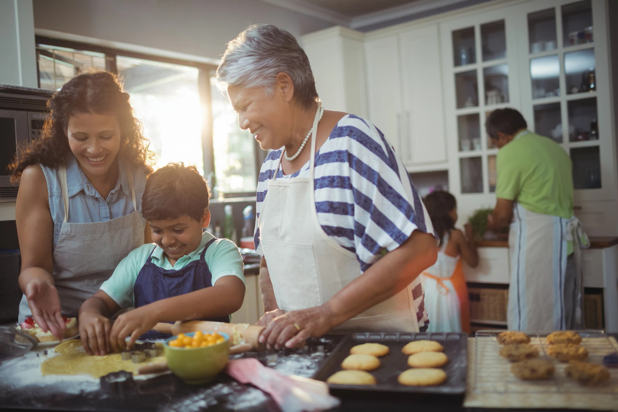 Family preparing desserts in kitchen at home