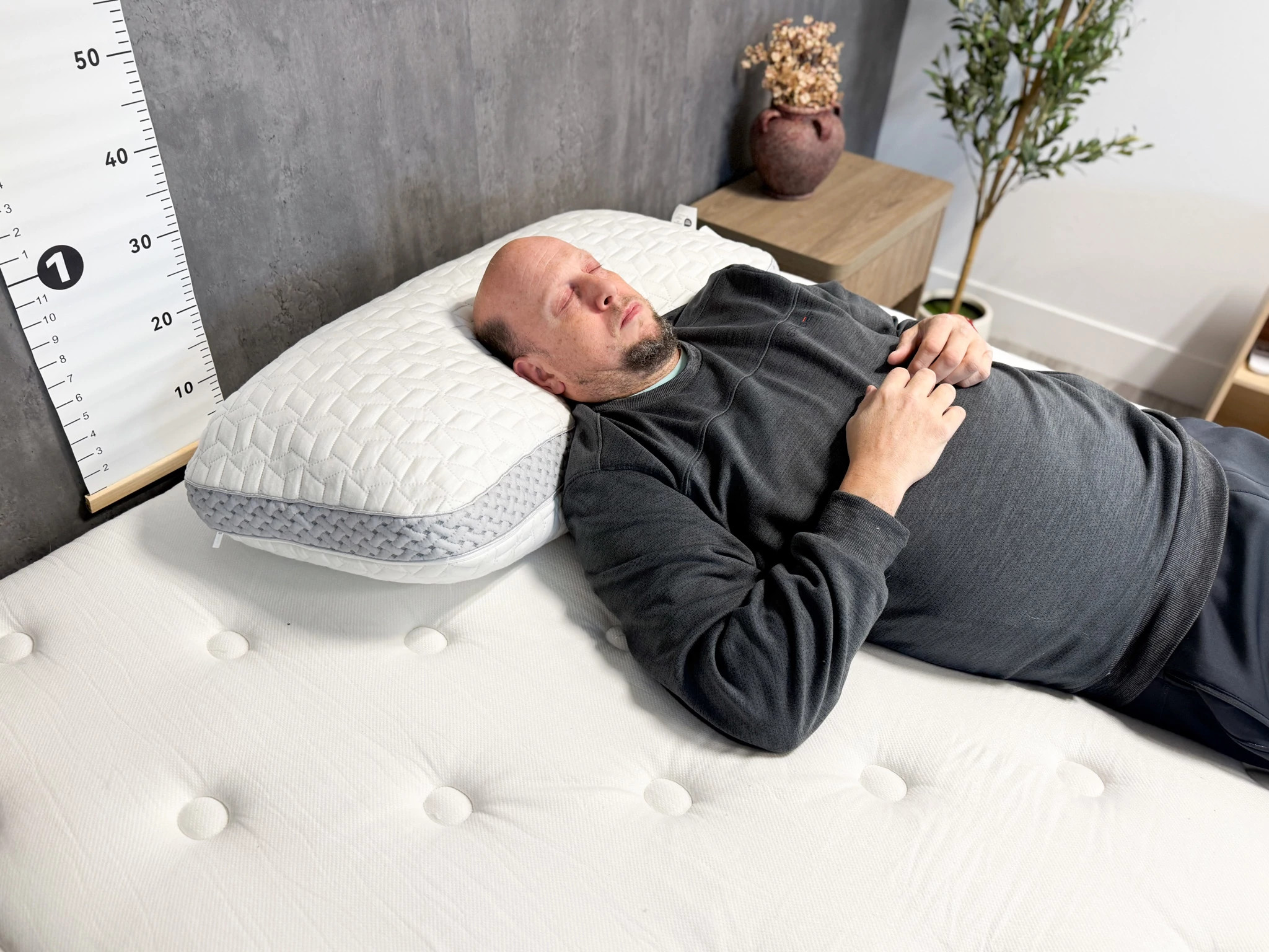 An older adult man testing the Luxome LAYR Customizable Pillow on his back.